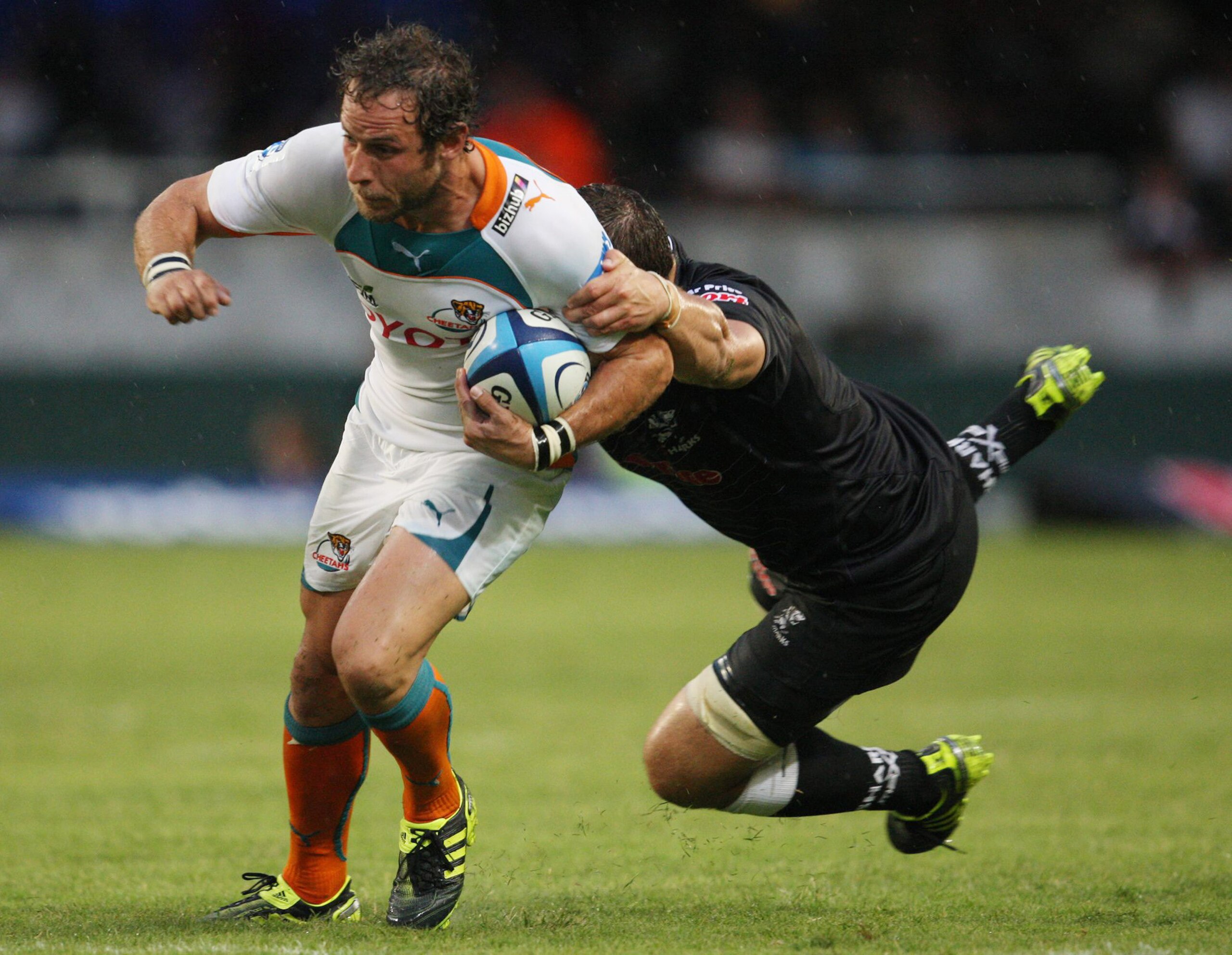 DURBAN, SOUTH AFRICA - FEBRUARY 19:  Andries Strauss of the Cheetahs is tackled by Willem Alberts of the Sharks during the Super Rugby Round 1 match between Sharks and Cheetahs at Mr Price Kings Park Stadium on February 19, 2011 in Durban, South Africa.
