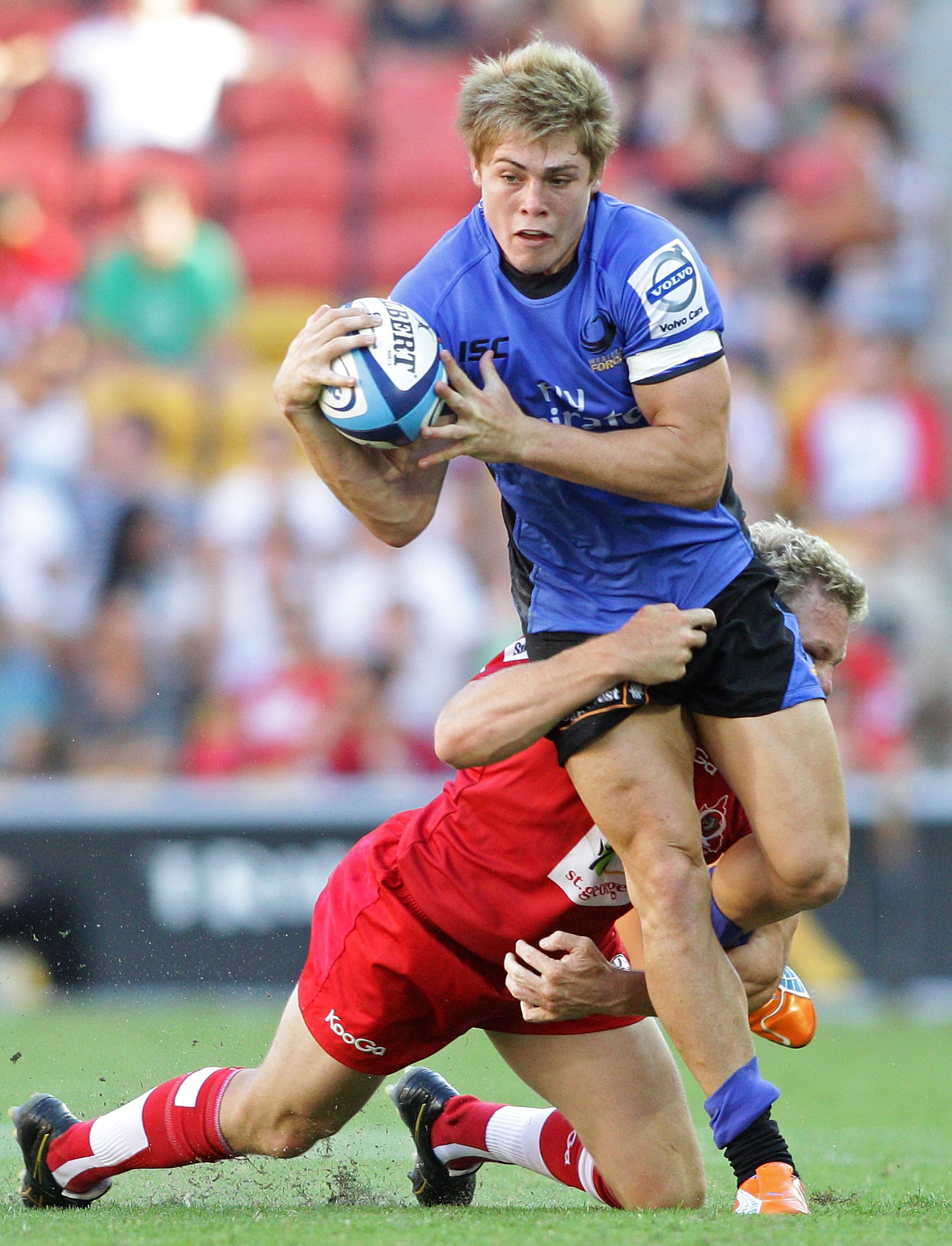 BRISBANE, AUSTRALIA - FEBRUARY 20: James O'Connor of the Force takes on the Reds defence during the round one Super Rugby match between the Reds and the Western Force at Suncorp Stadium on February 20, 2011 in Brisbane, Australia.  (Photo by Bradley Kanar
