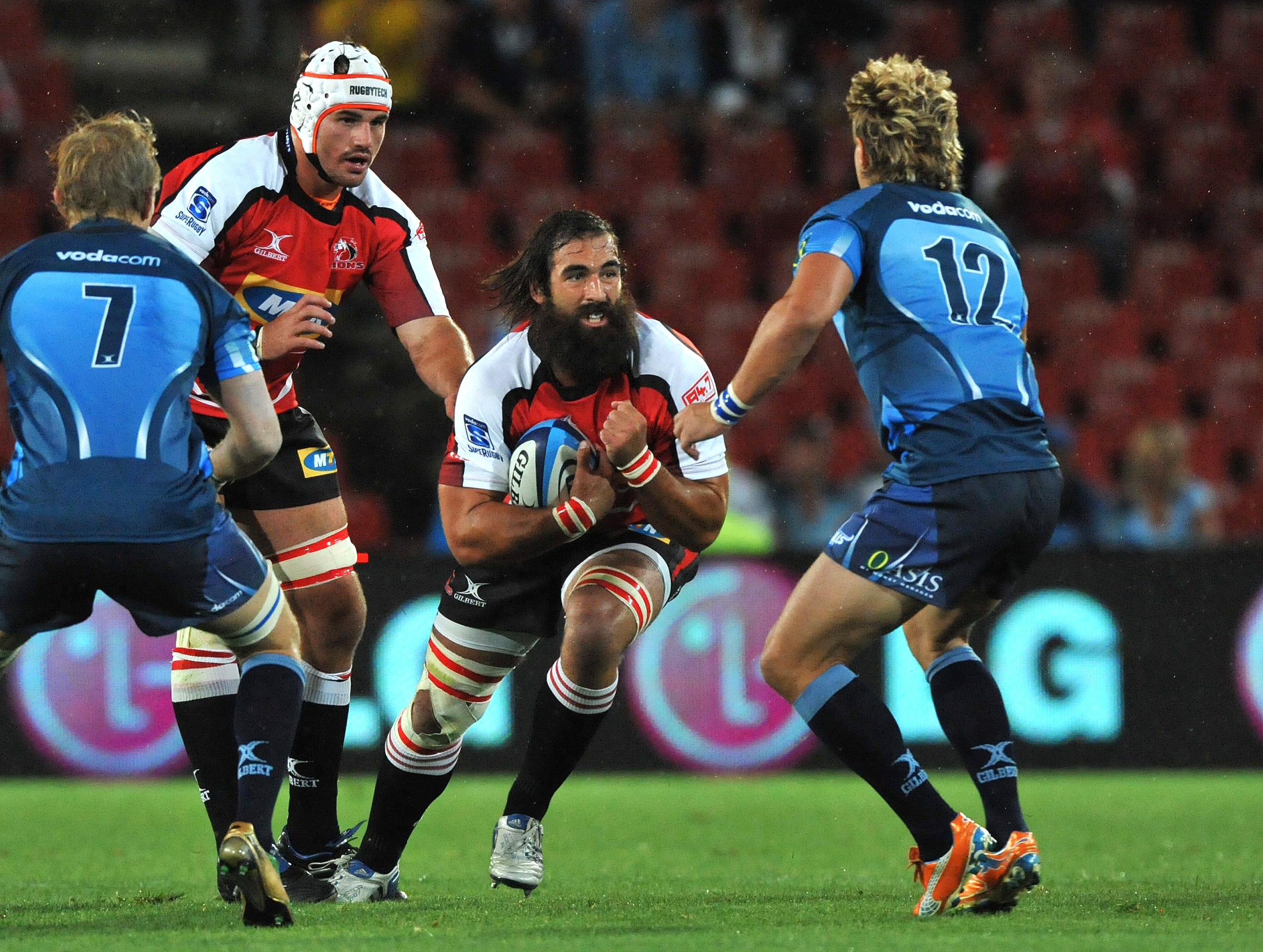 JOHANNESBURG, SOUTH AFRICA - FEBRUARY 19:  Josh Strauss of the Lions charges into Wynand Olivier of the Bulls during the Super Rugby Round 1 match between Lions and Vodacom Bulls at Coca Cola Park on February 19, 2011 in Johannesburg, South Africa.  (Phot