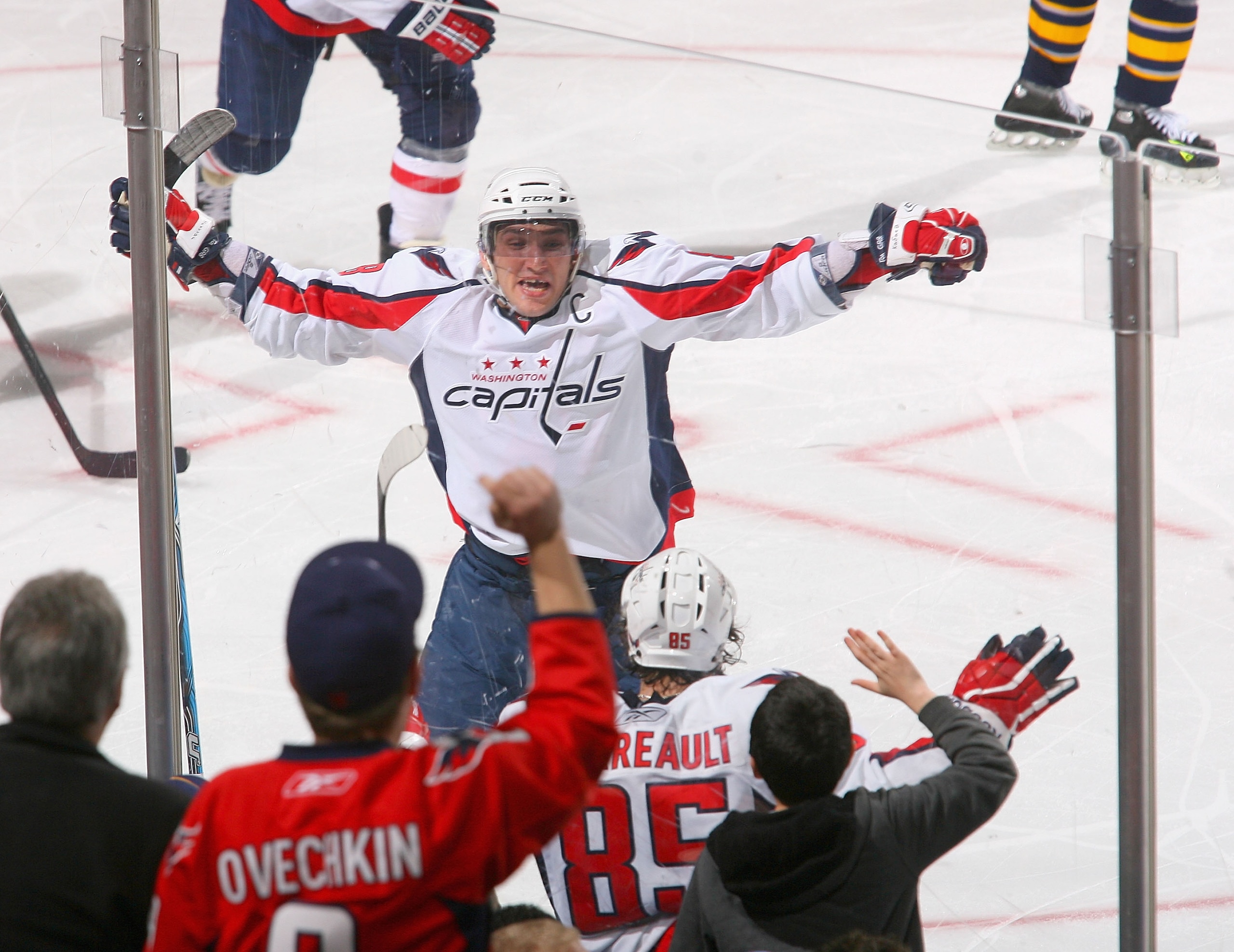 BUFFALO, NY - FEBRUARY 20: Alex Ovechkin #8 and Mathieu Perrault #85 of the Washington Capitals celebrate the game winning goal by Marcus Johansson #90 (not shown) against the Buffalo Sabres  at HSBC Arena on February 20, 2011 in Buffalo, New York.  (Phot