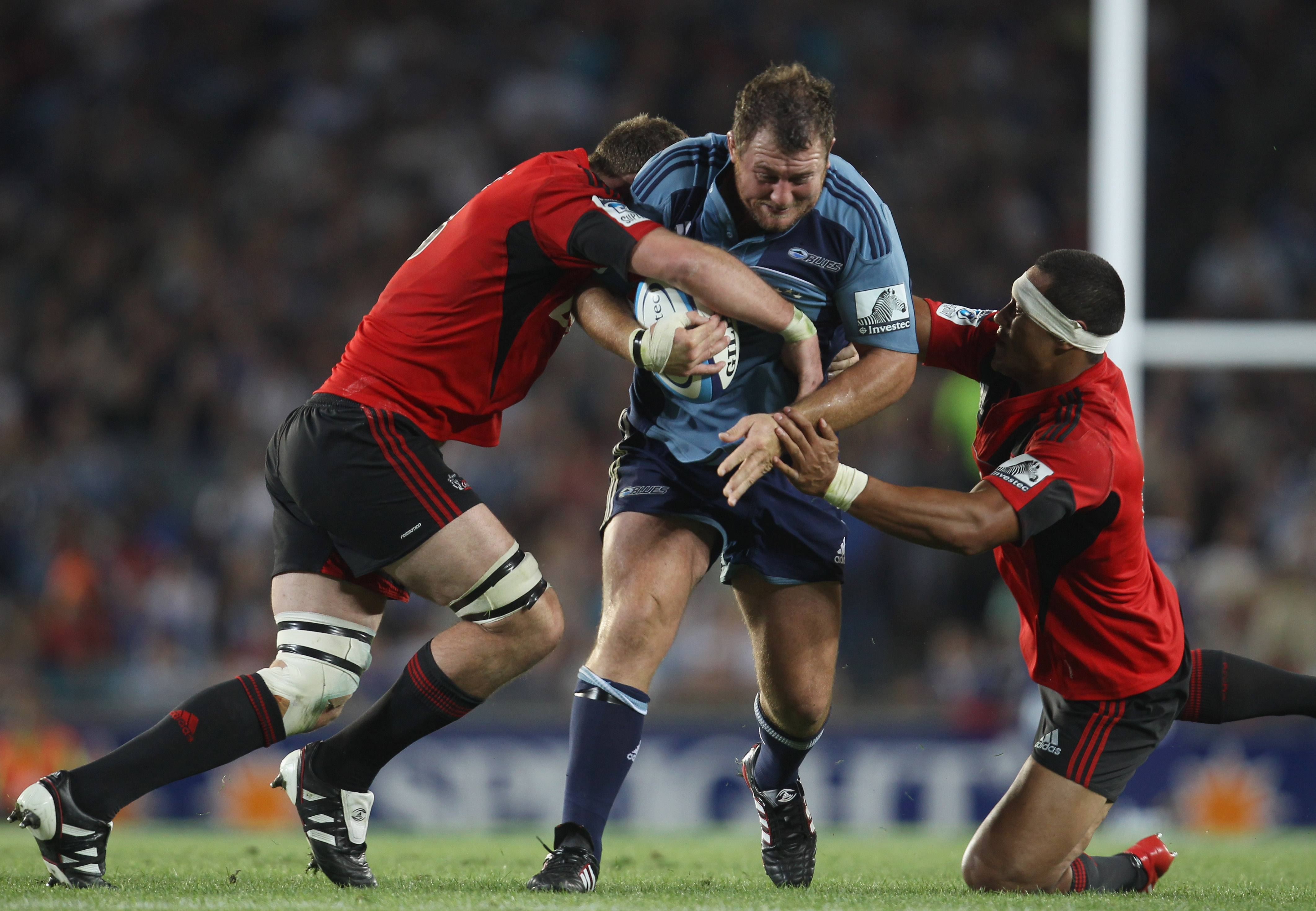 AUCKLAND, NEW ZEALAND - FEBRUARY 19: Tony Woodcock of the Blues is tackled by the Crusaders defence during the round one Super Rugby match between the Blues and the Crusaders at Eden Park on February 19, 2011 in Auckland, New Zealand.  (Photo by Phil Walt