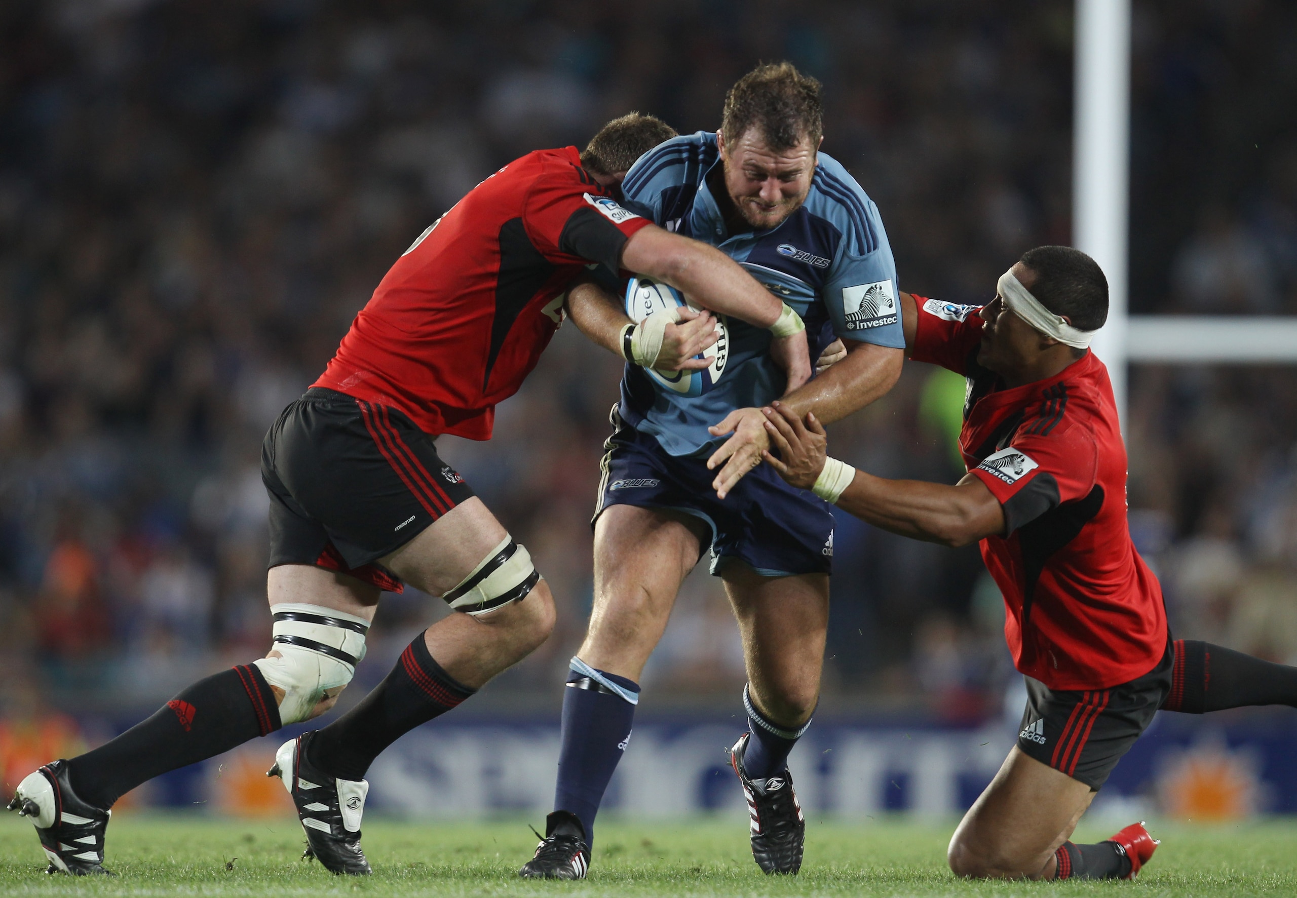 AUCKLAND, NEW ZEALAND - FEBRUARY 19: Tony Woodcock of the Blues is tackled by the Crusaders defence during the round one Super Rugby match between the Blues and the Crusaders at Eden Park on February 19, 2011 in Auckland, New Zealand.  (Photo by Phil Walt