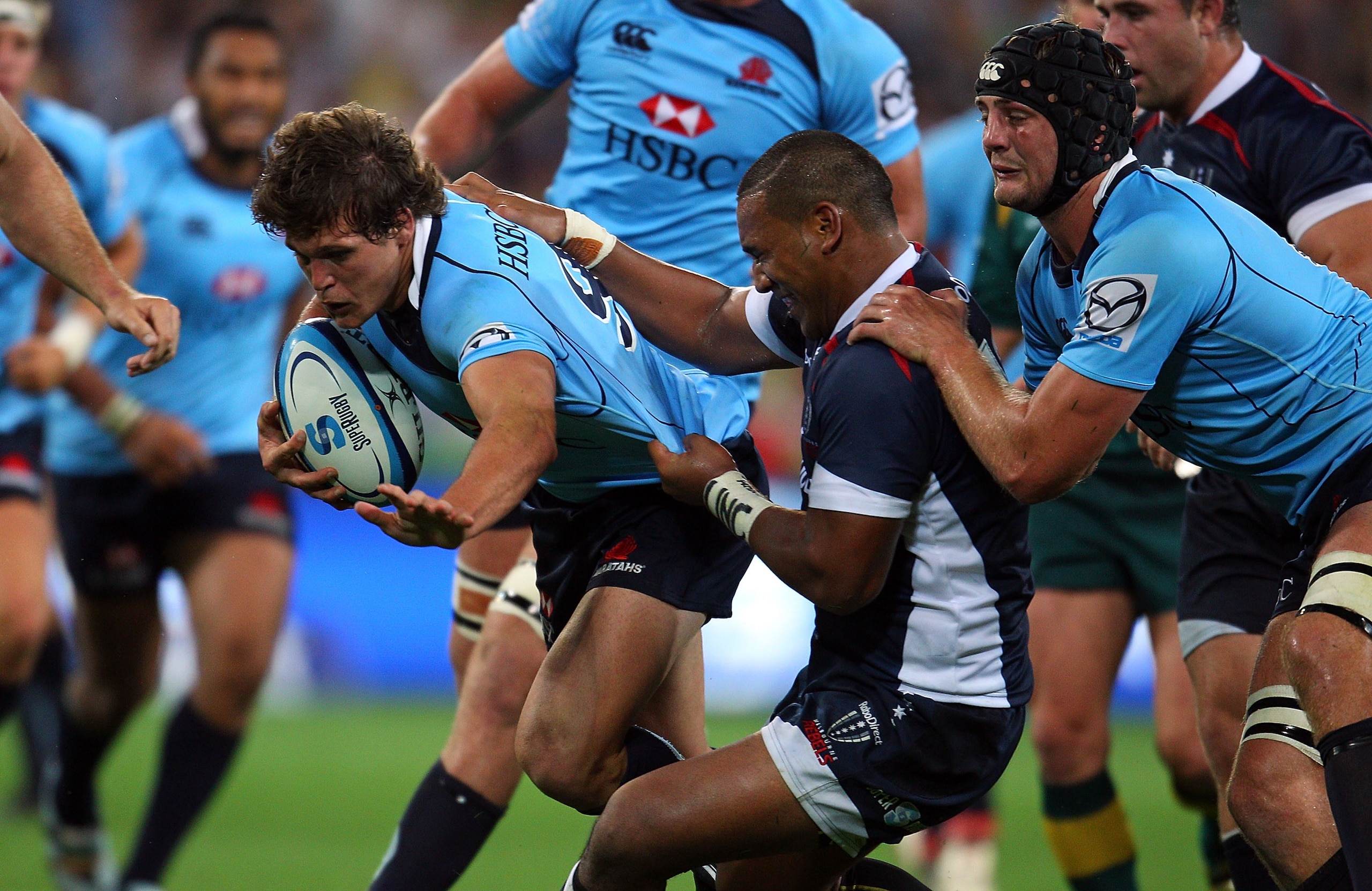 MELBOURNE, AUSTRALIA - FEBRUARY 18:  Luke Burgess of the Waratahs is tackled during the round one Super Rugby match between the Melbourne Rebels and the Waratahs at AAMI Park on February 18, 2011 in Melbourne, Australia.  (Photo by Scott Barbour/Getty Ima