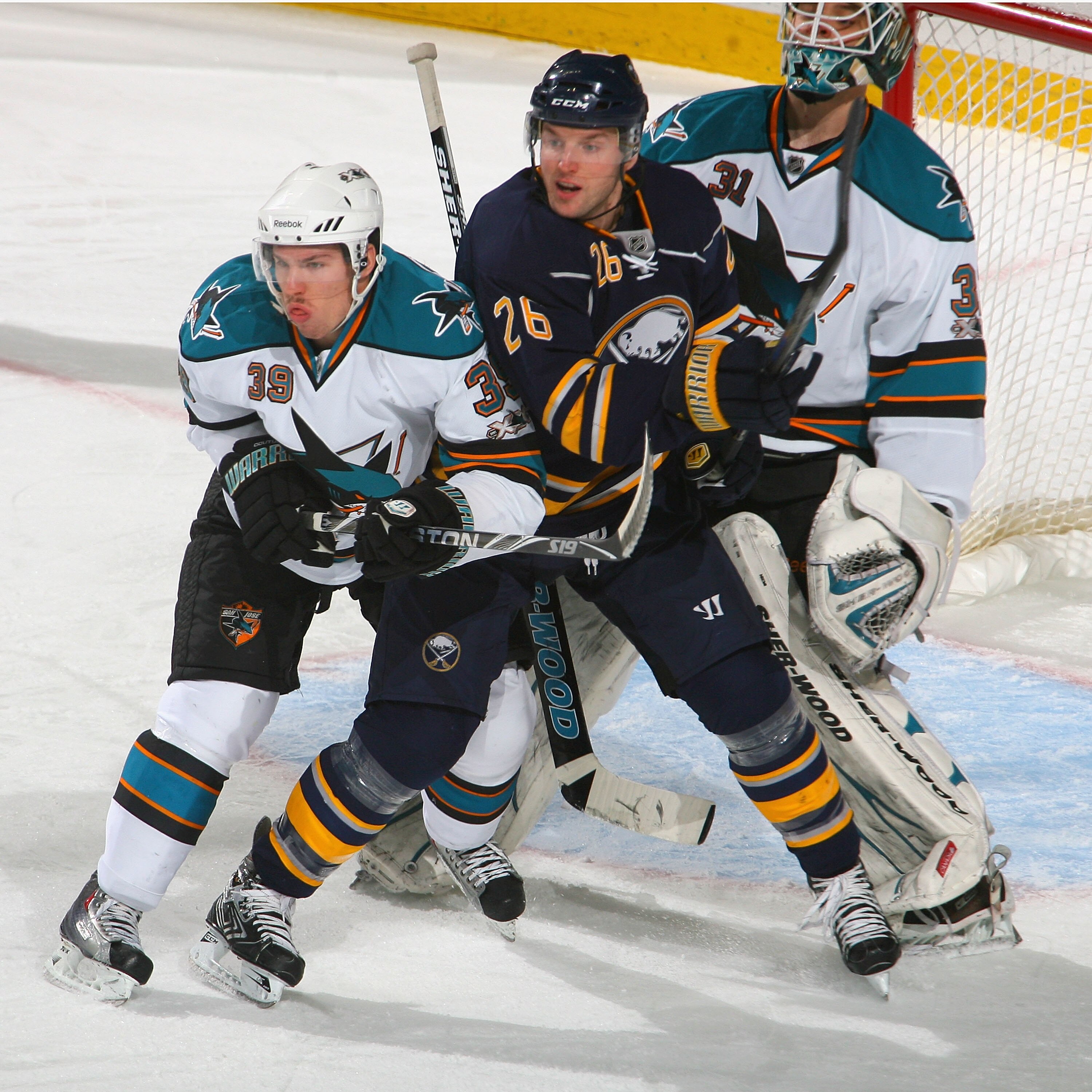 BUFFALO, NY - DECEMBER 09: Logan Couture #39 and Antii Niemi #31 of the San Jose Sharks defend against Thomas Vanek #26 of the Buffalo Sabres at HSBC Arena on December 9, 2010 in Buffalo, New York.  (Photo by Rick Stewart/Getty Images)