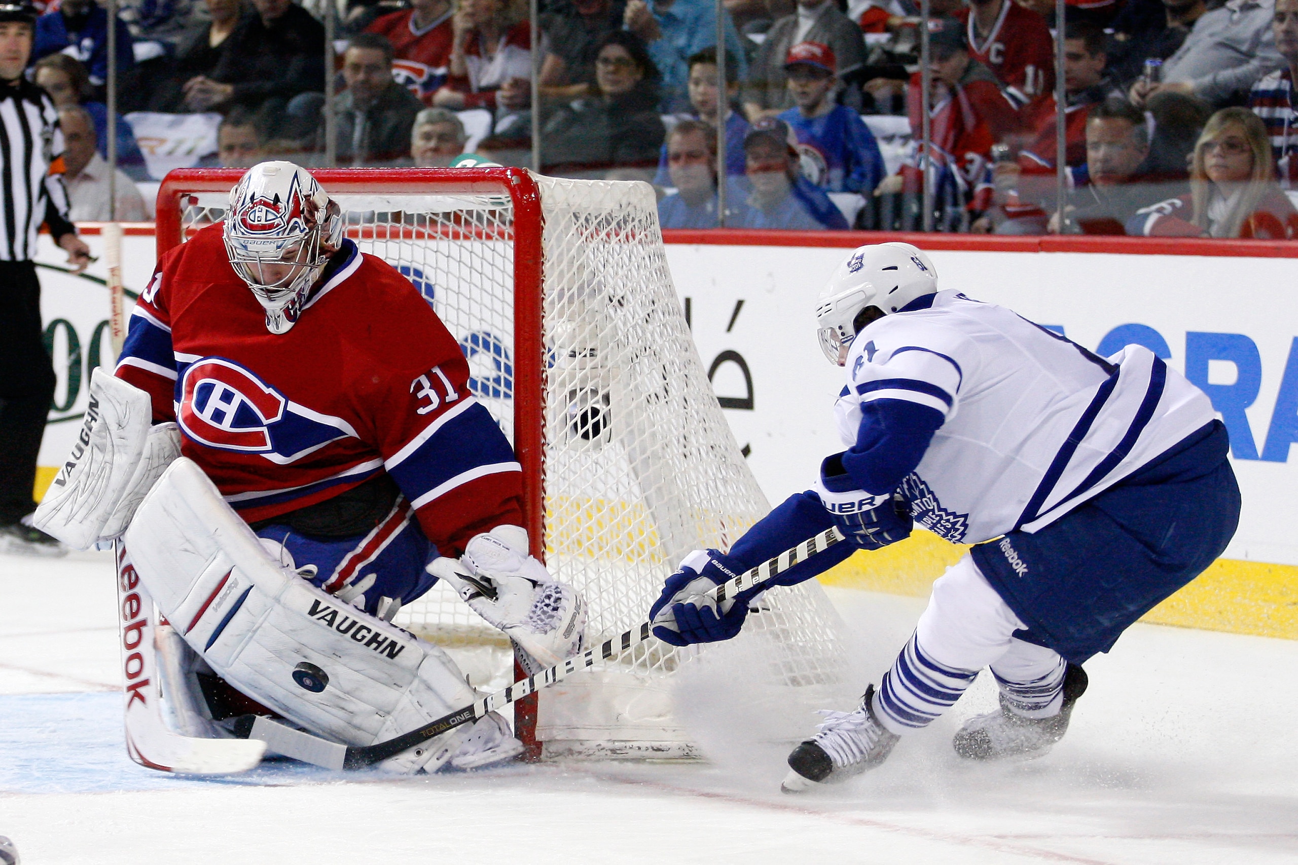 MONTREAL, CANADA - FEBRUARY 12:  Carey Price #31 of the Montreal Canadiens stops the puck on an attempt by Phil Kessel #81 of the Toronto Maple Leafs during the NHL game at the Bell Centre on February 12, 2011 in Montreal, Quebec, Canada.  The Canadiens d