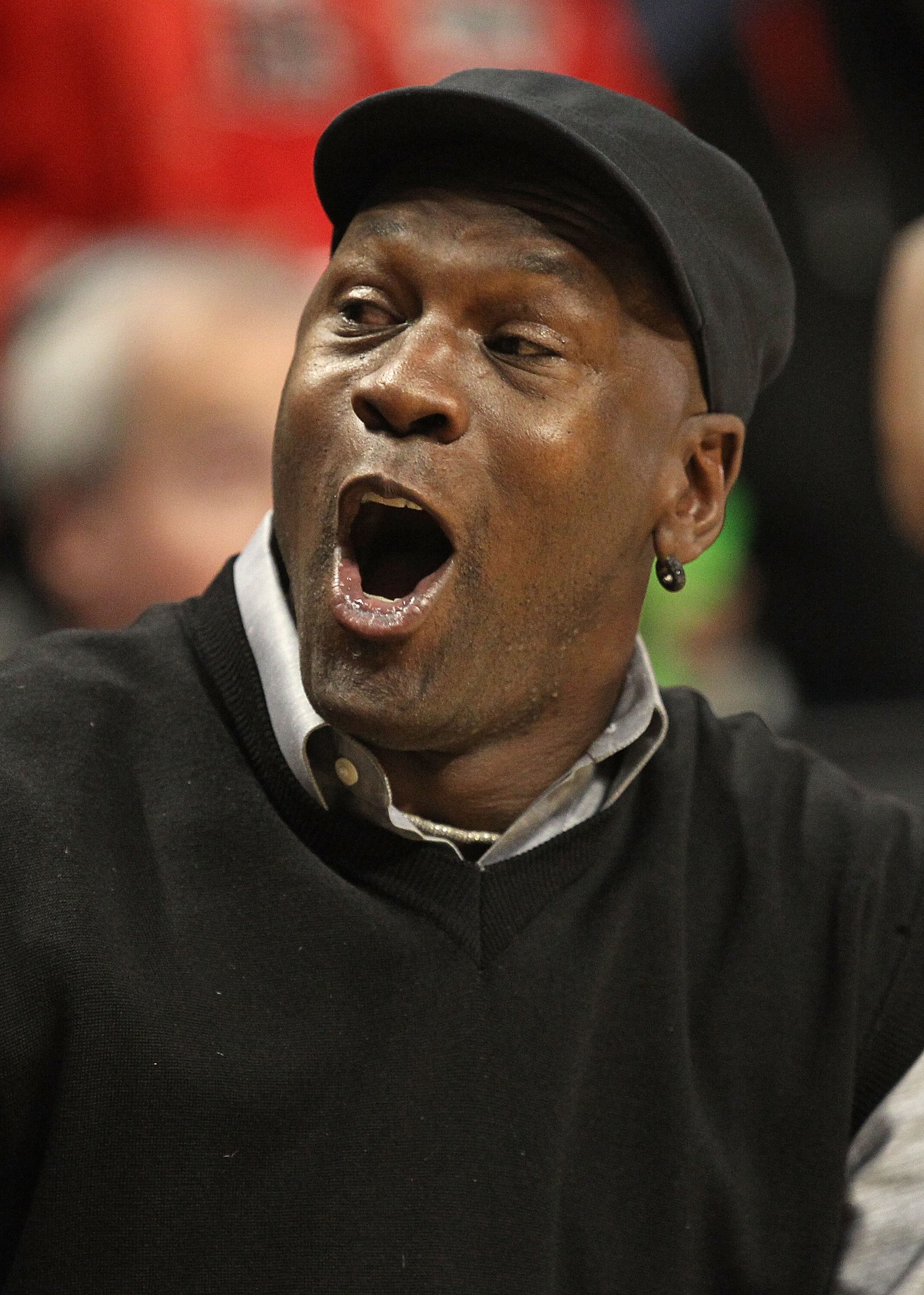 CHICAGO, IL - FEBRUARY 15: Former player Michael Jordan of the Chicago Bulls talks to a fan before the Bulls take on the Charlotte Bobcats at the United Center on February 15, 2011 in Chicago, Illinois. NOTE TO USER: User expressly acknowledges and agrees