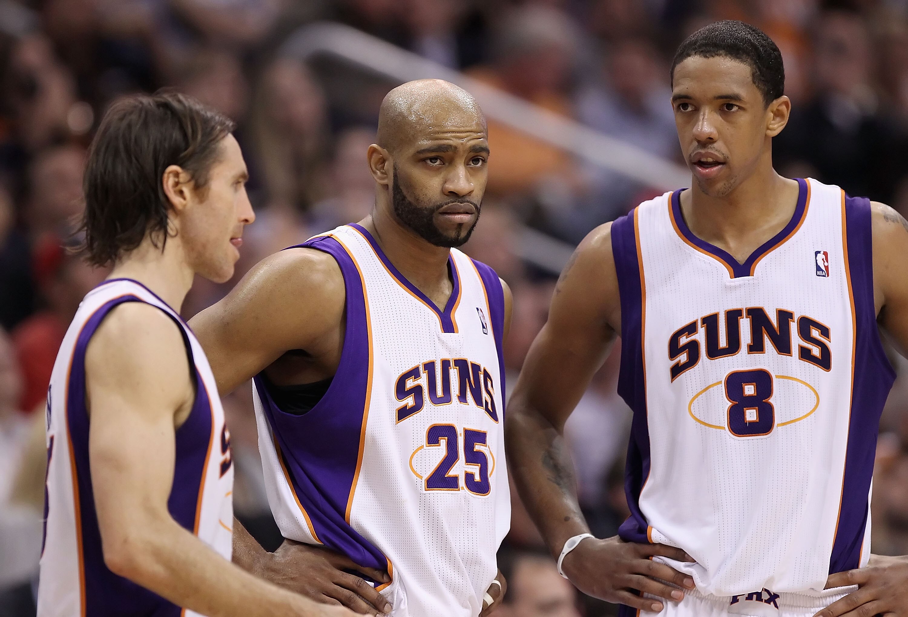 PHOENIX, AZ - FEBRUARY 17:  (L-R) Steve Nash #13, Vince Carter #25 and Channing Frye #8 of the Phoenix Suns react during a break from the NBA game against the Dallas Mavericks at US Airways Center on February 17, 2011 in Phoenix, Arizona.  The Mavericks d