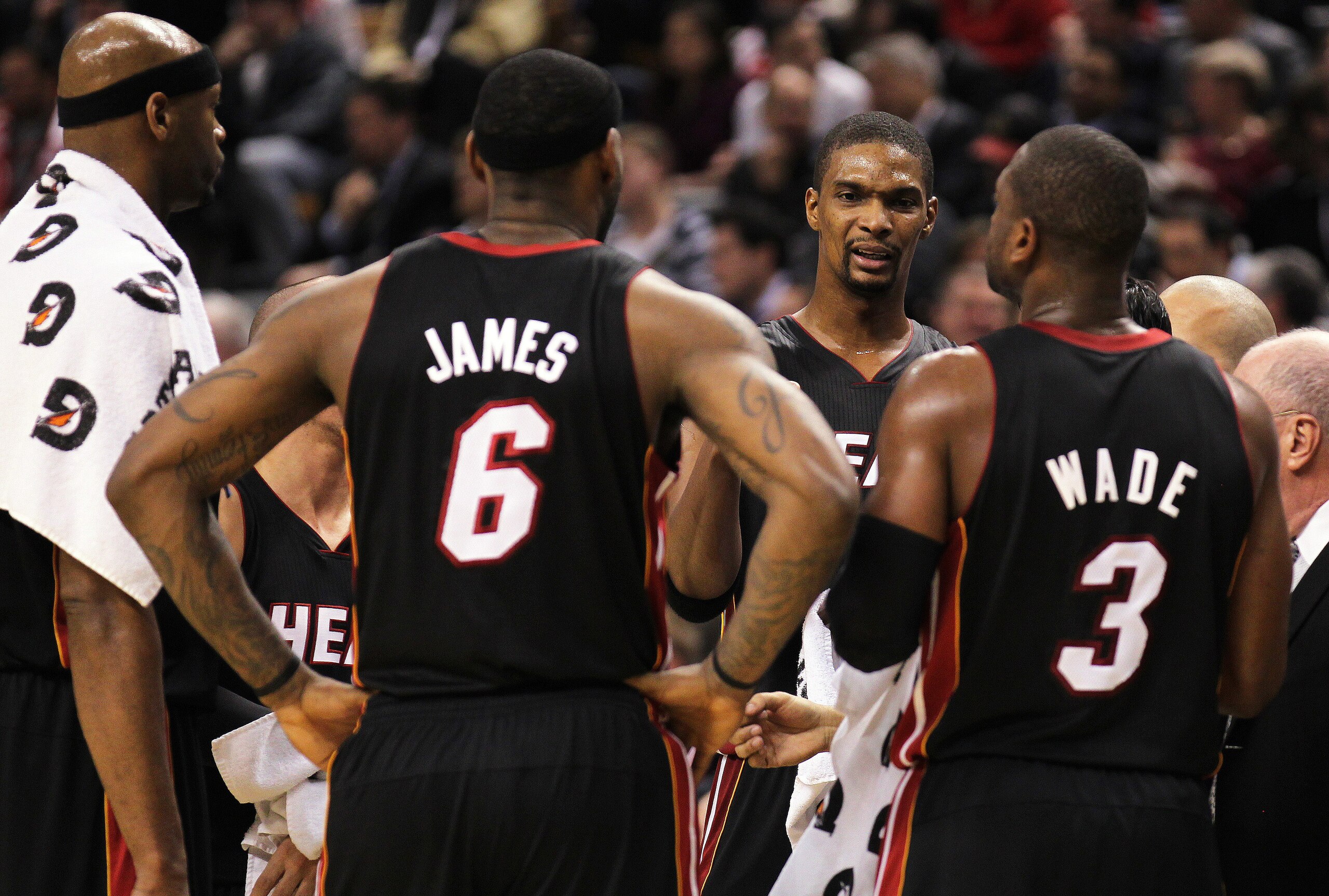 TORONTO, CANADA - FEBRUARY 16: Chris Bosh #1 of the Miami Heat talks to teammates LeBron James #6 and Dwyane Wade #3 during a timeout in a game against the Toronto Raptors on February 16, 2011 at the Air Canada Centre in Toronto, Canada. The Heat defeate TORONTO, CANADA - FEBRUARY 16: Chris Bosh #1 of the Miami Heat talks to teammates LeBron James #6 and Dwyane Wade #3 during a timeout in a game against the Toronto Raptors on February 16, 2011 at the Air Canada Centre in Toronto, Canada. The Heat defeate