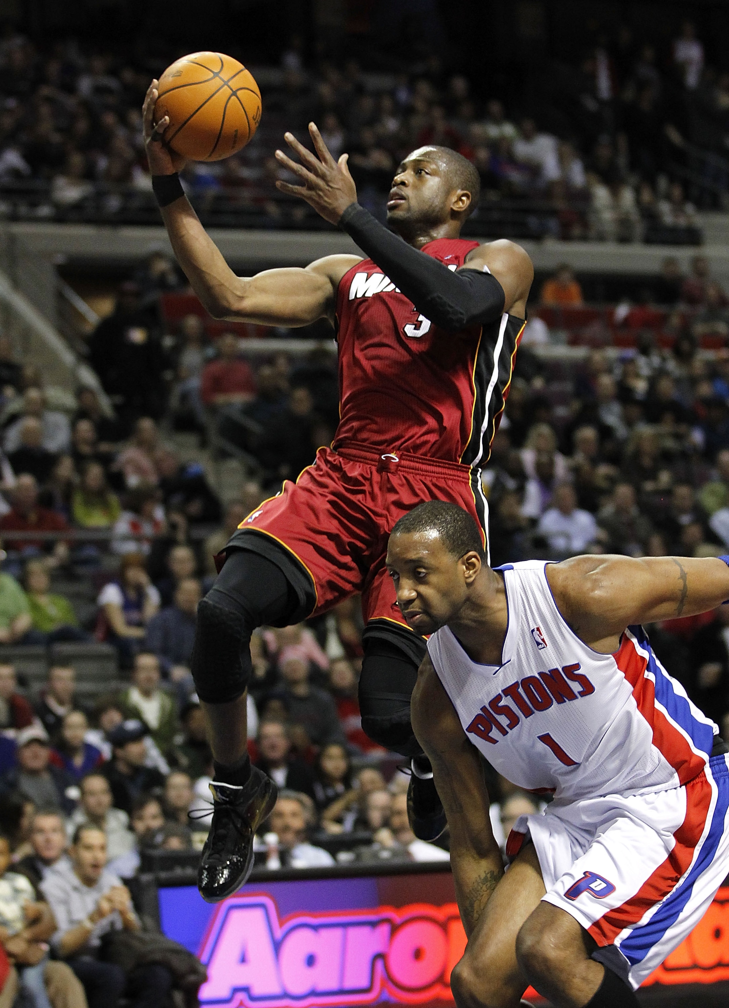 AUBURN HILLS, MI - FEBRUARY 11:  Dwyane Wade #3 of the Miami Heat gets to the basket in front of Tracy McGrady #1 of the Detroit Pistons at The Palace of Auburn Hills on February 11, 2011 in Auburn Hills, Michigan. NOTE TO USER: User expressly acknowledge