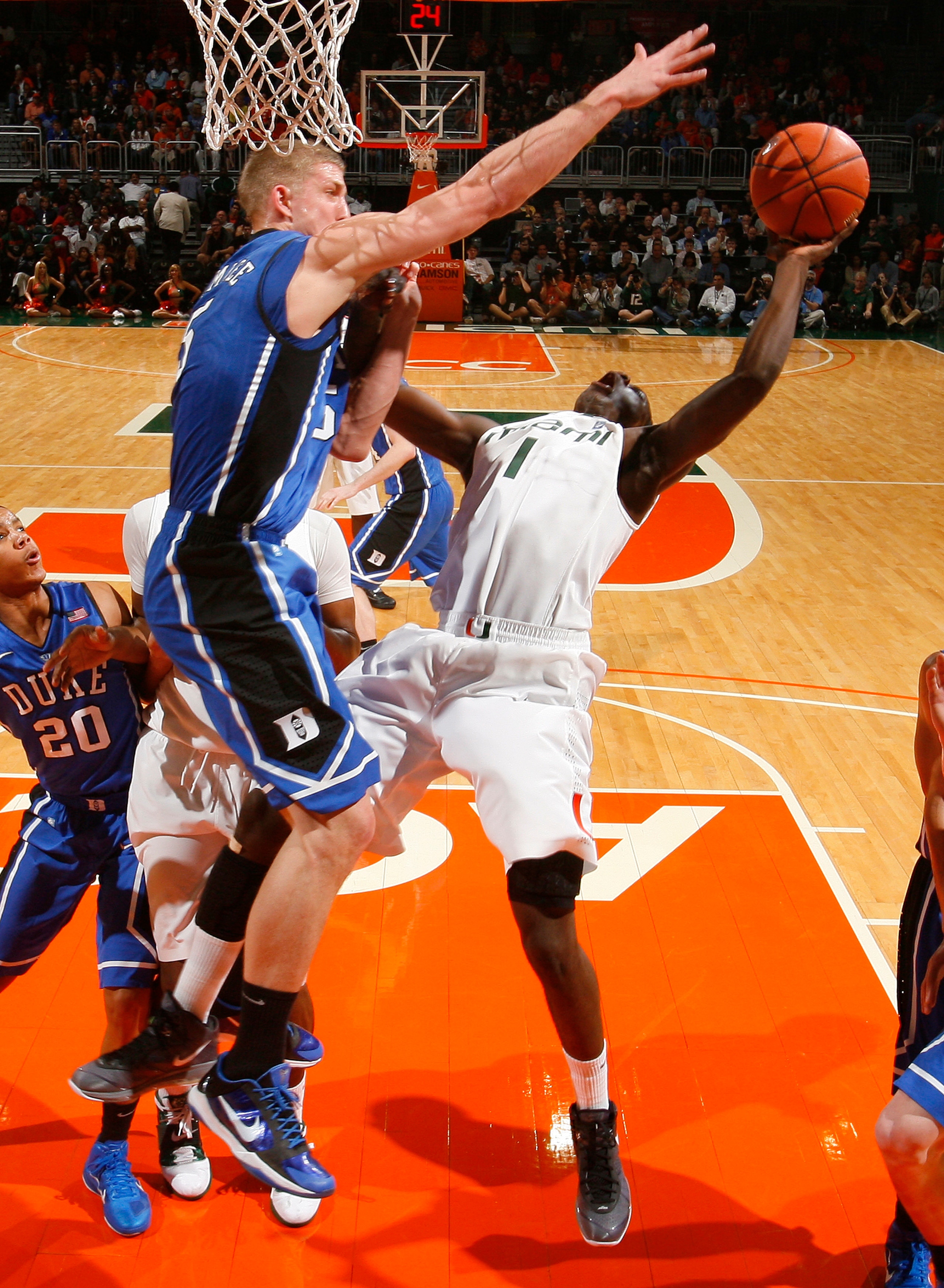 CORAL GABLES, FL - FEBRUARY 13: Mason Plumlee #5 of the Duke Blue Devils goes up to block the shot by Durand Scott #1 of the Miami Hurricanes on February 13, 2011 at the BankUnited Center in Coral Gables, Florida. The Blue Devils defeated the Hurricanes 8 CORAL GABLES, FL - FEBRUARY 13: Mason Plumlee #5 of the Duke Blue Devils goes up to block the shot by Durand Scott #1 of the Miami Hurricanes on February 13, 2011 at the BankUnited Center in Coral Gables, Florida. The Blue Devils defeated the Hurricanes 8