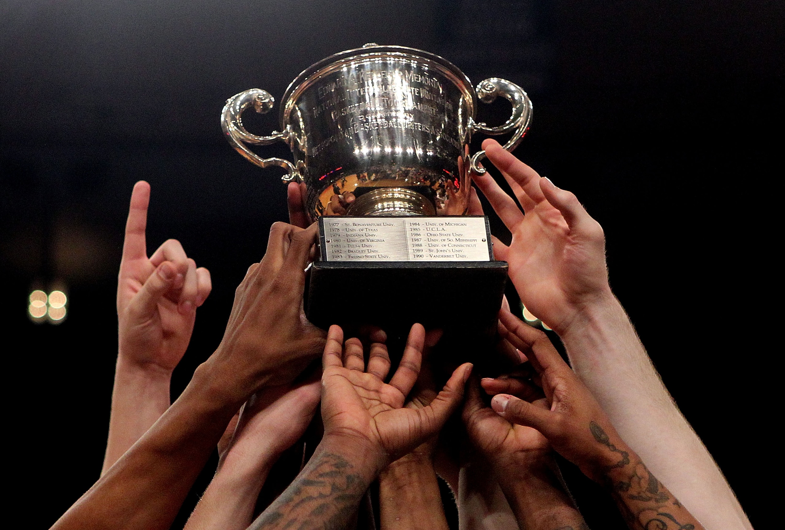 NEW YORK - APRIL 01:  The Dayton Flyers hold aloft the trophy to celebrate defeating the North Carolina Tar Heels during the 2010 NIT Championship Game at Madison Square Garden on April 1, 2010 in New York, New York.  (Photo by Nick Laham/Getty Images)