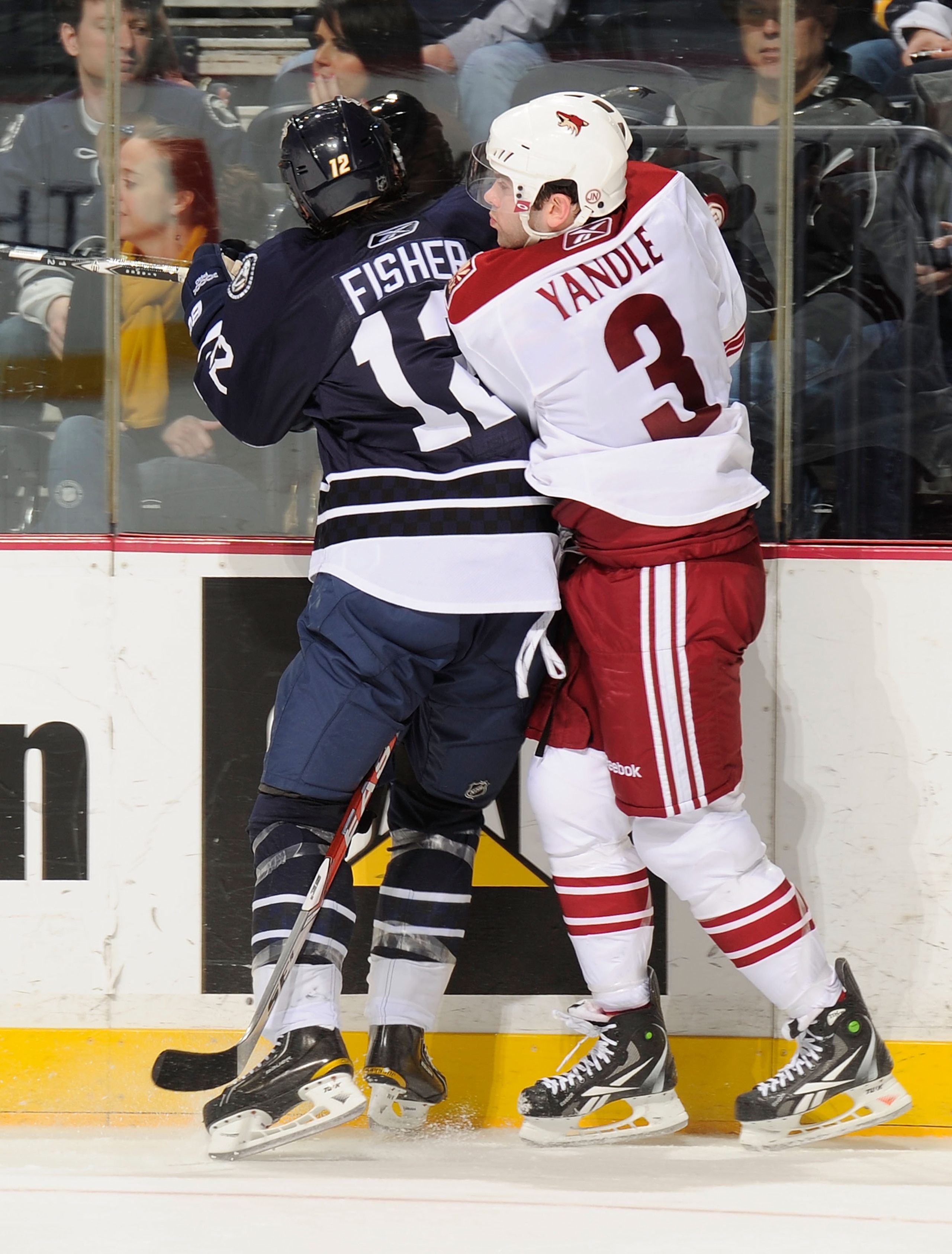 NASHVILLE, TN - FEBRUARY 19:  Keith Yandle #3 of the Phoenix Coyotes checks Mike Fisher #12 of the Nashville Predators on February 19, 2011 at the Bridgestone Arena in Nashville, Tennessee.  (Photo by Frederick Breedon/Getty Images)