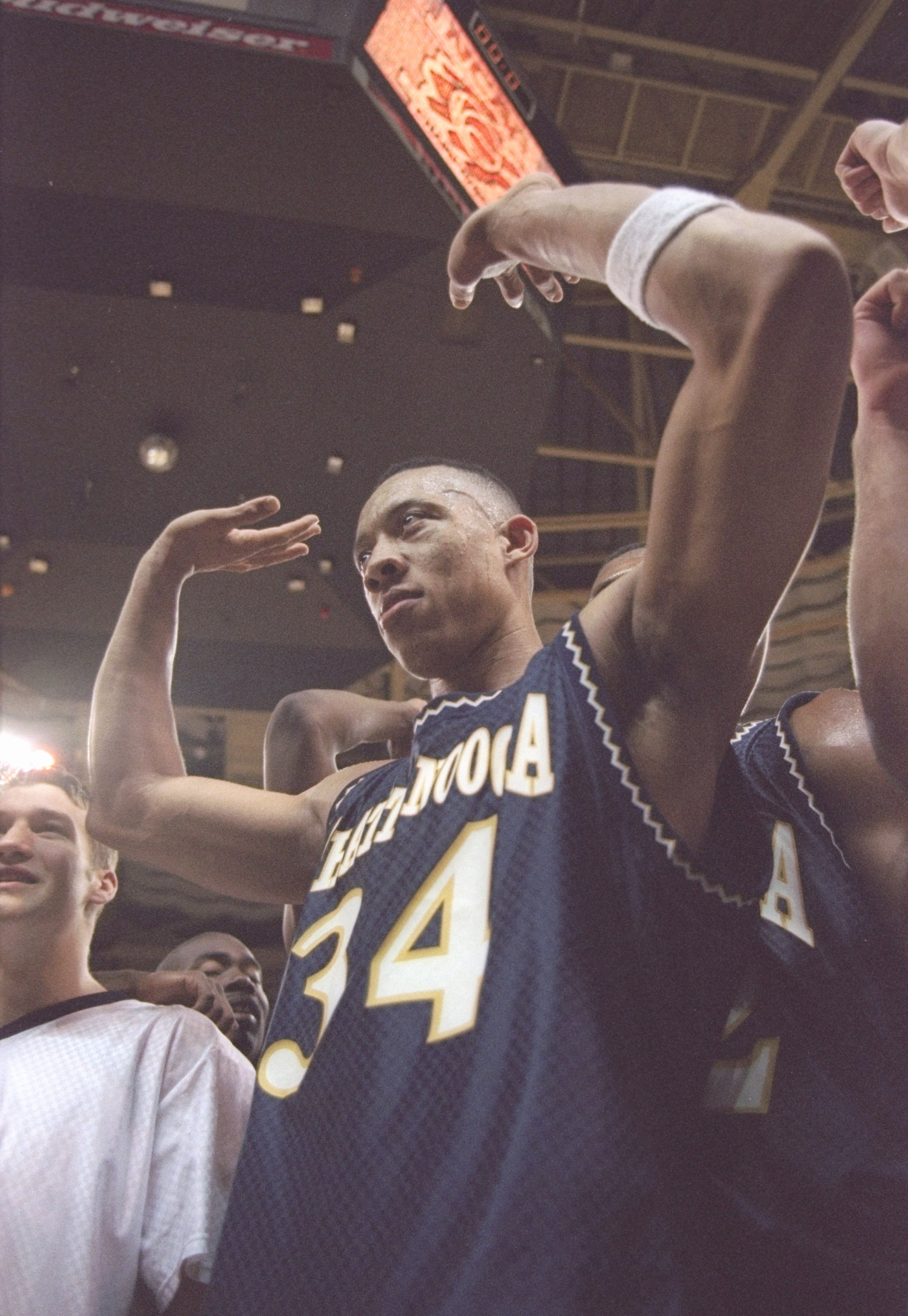 16 Mar 1997: Center Chris Mims of University of Tennessee at Chattanooga Moccasins celebrates after a playoff game against the Illinois Fighting Illini at the Charlotte Coliseum in Charlotte, North Carolina. Chatanooga won the game 73 - 63.