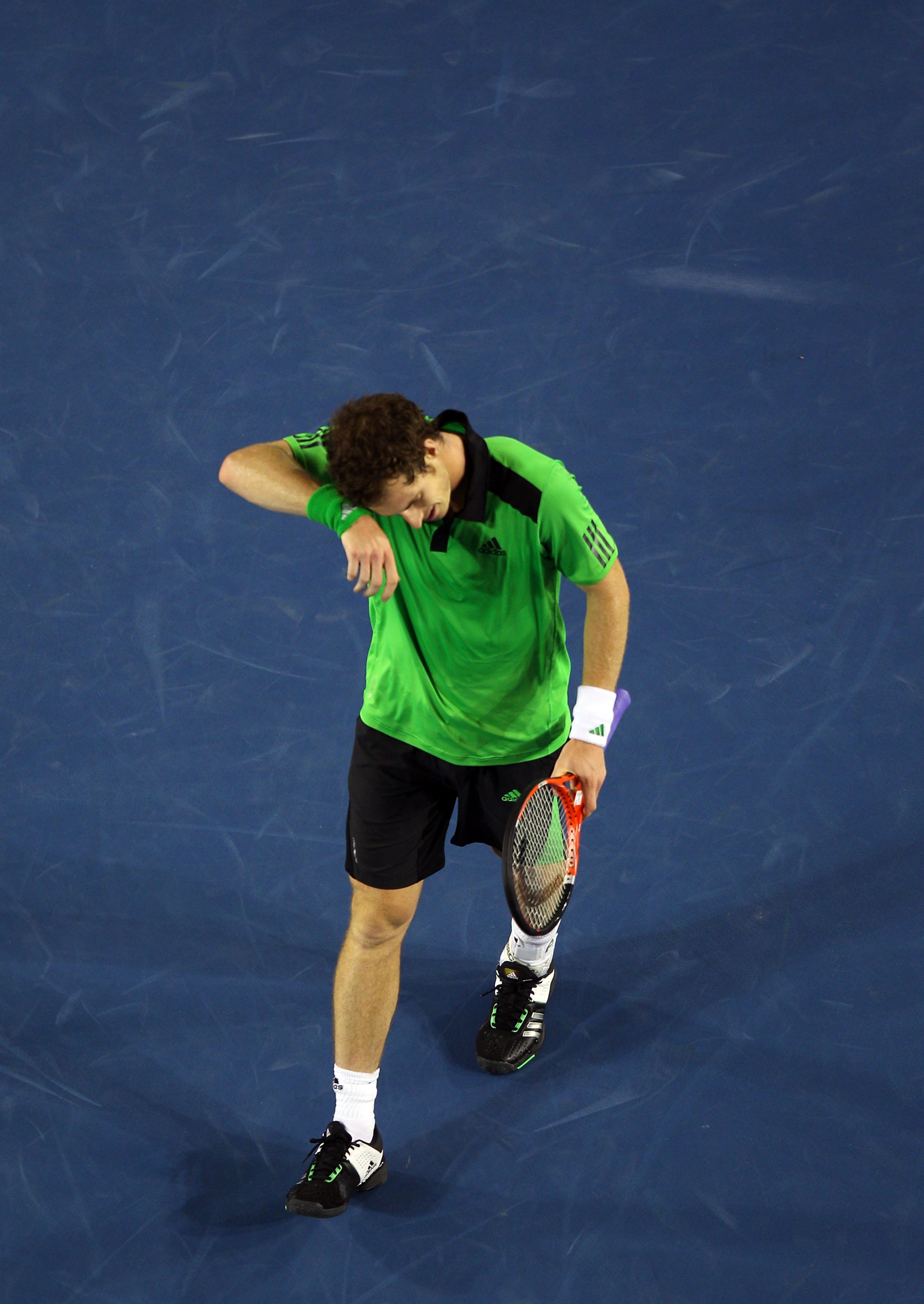 MELBOURNE, AUSTRALIA - JANUARY 30:  Andy Murray of Great Britain wipes his forehead in his men's final match against Novak Djokovic of Serbia during day fourteen of the 2011 Australian Open at Melbourne Park on January 30, 2011 in Melbourne, Australia.  (