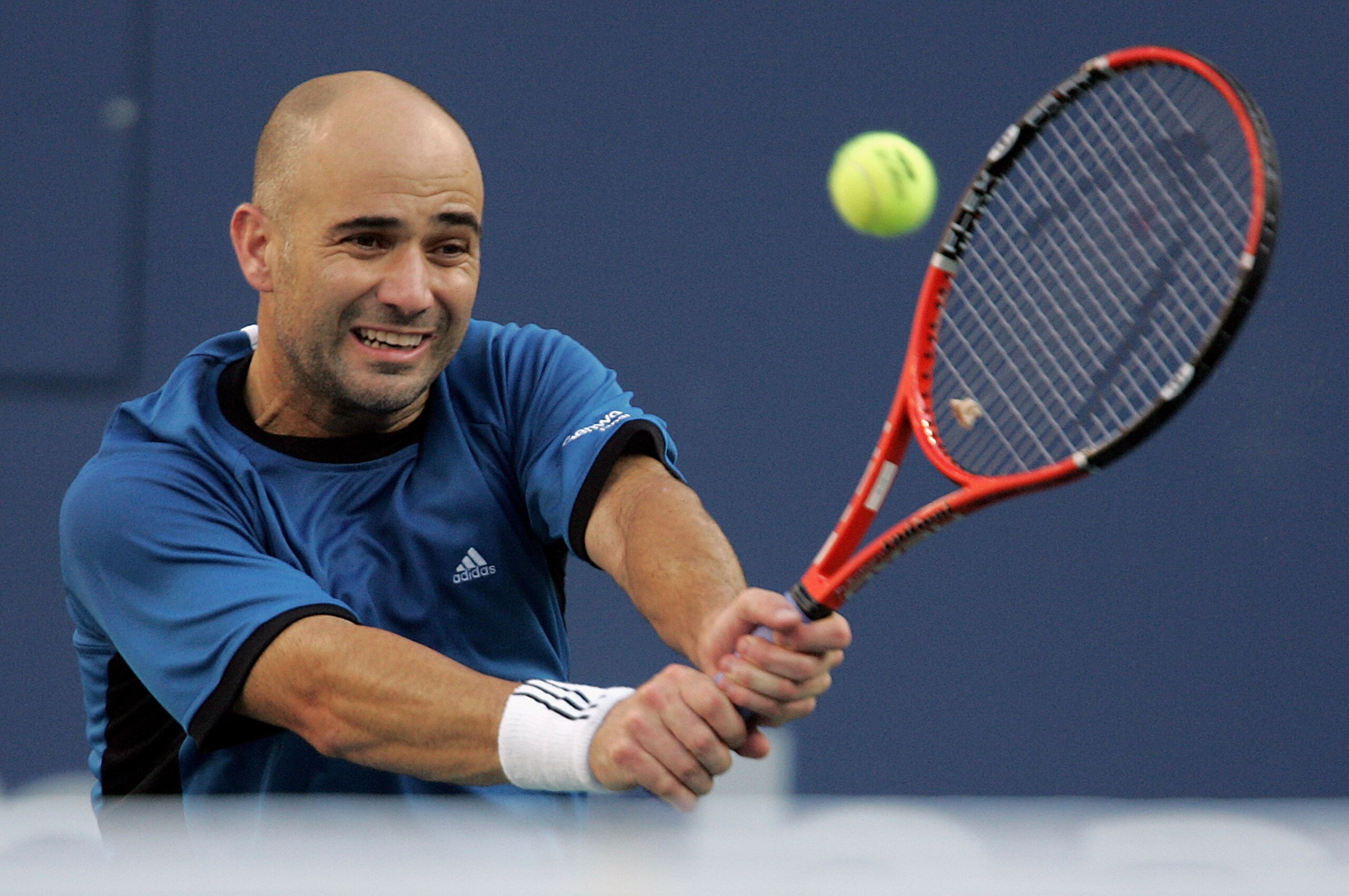 NEW YORK - SEPTEMBER 11:  Andre Agassi returns a backhand to Roger Federer of Switzerland during the men's final of the US Open at the USTA National Tennis Center in Flushing Meadows Corona Park on September 11, 2005 in the Flushing neighborhood of the Qu