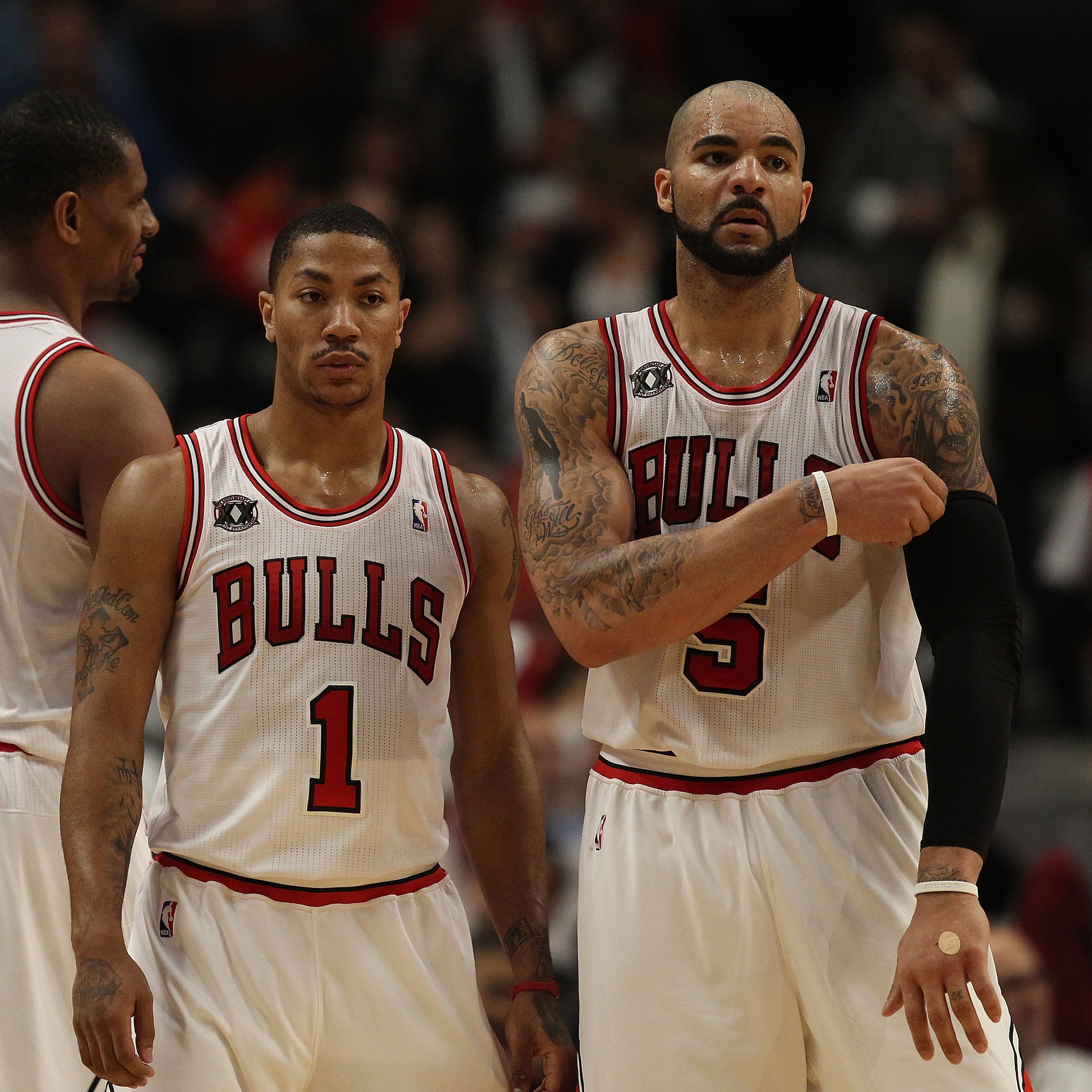 CHICAGO, IL - FEBRUARY 17: Derrick Rose #1 and Carlos Boozer #5 of the Chicago Bulls return to the court after a time-out against the San Antonio Spurs at the United Center on February 17, 2011 in Chicago, Illinois. The Bulls defeated the Spurs 109-99. NO