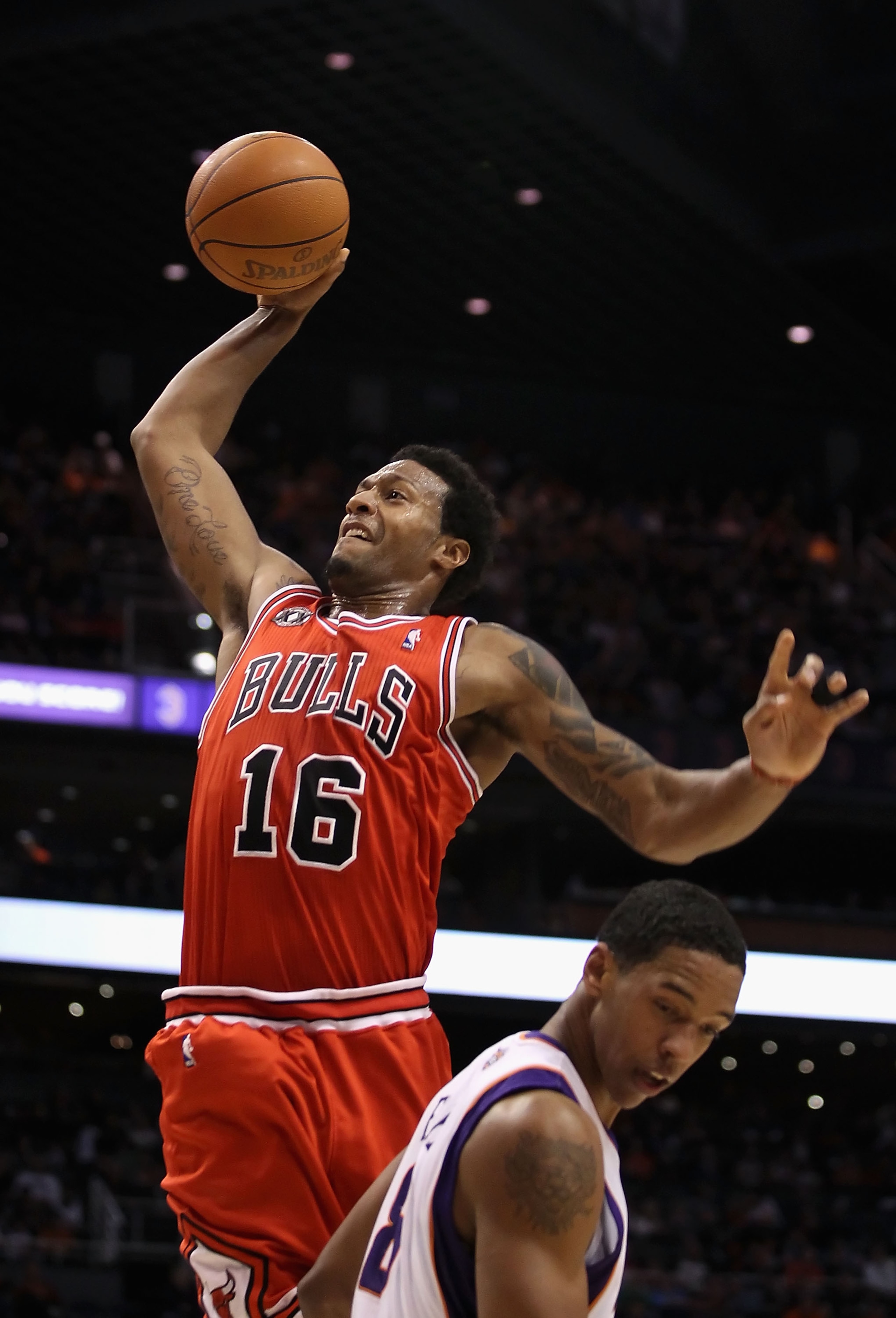 PHOENIX - NOVEMBER 24:  James Johnson #16 of the Chicago Bulls goes up for a slam dunk over Channing Frye #8 of the Phoenix Suns during the NBA game at US Airways Center on November 24, 2010 in Phoenix, Arizona. NOTE TO USER: User expressly acknowledges a