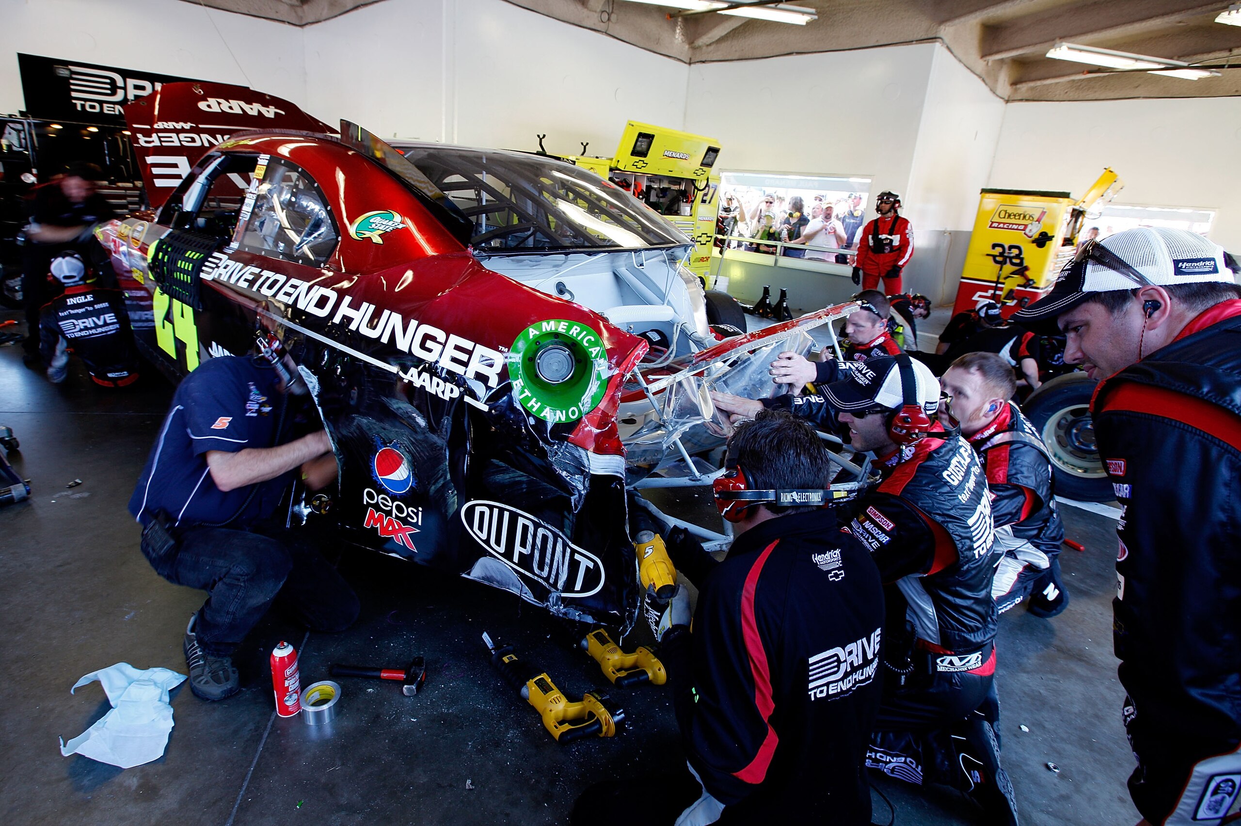 DAYTONA BEACH, FL - FEBRUARY 20:  Crew members work on the #24 Drive to End Hunger Chevrolet of Jeff Gordon during the NASCAR Sprint Cup Series Daytona 500 at Daytona International Speedway on February 20, 2011 in Daytona Beach, Florida.  (Photo by Chris