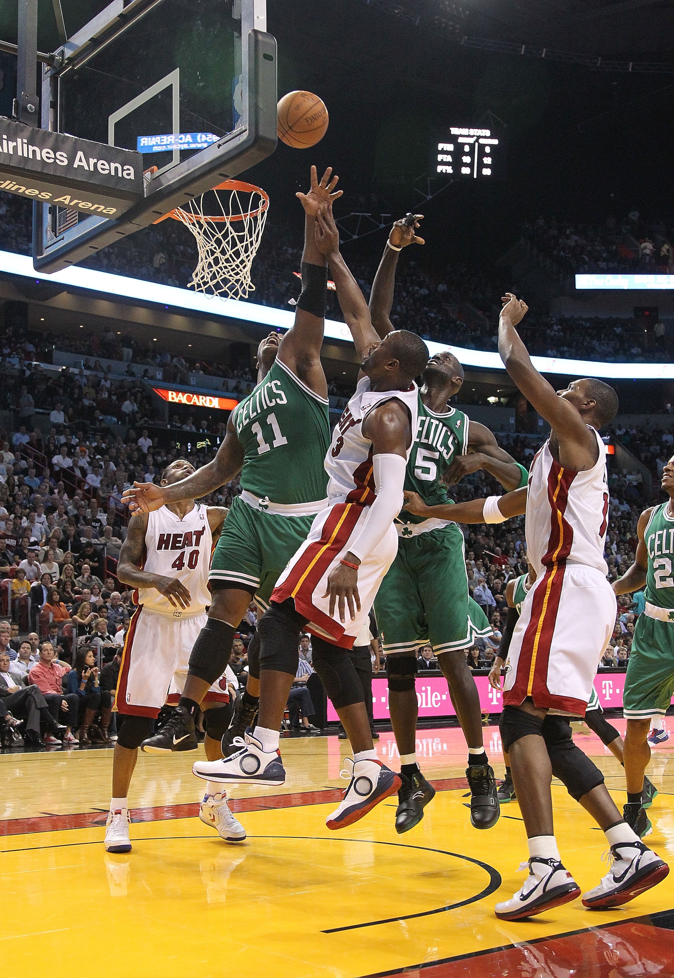 MIAMI - NOVEMBER 11:  Dwyane Wade #3  of the Miami Heat shoots over Glen Davis #11 and Kevin Garnett #5 during a game against the Utah Jazz at American Airlines Arena on November 9, 2010 in Miami, Florida. NOTE TO USER: User expressly acknowledges and agr
