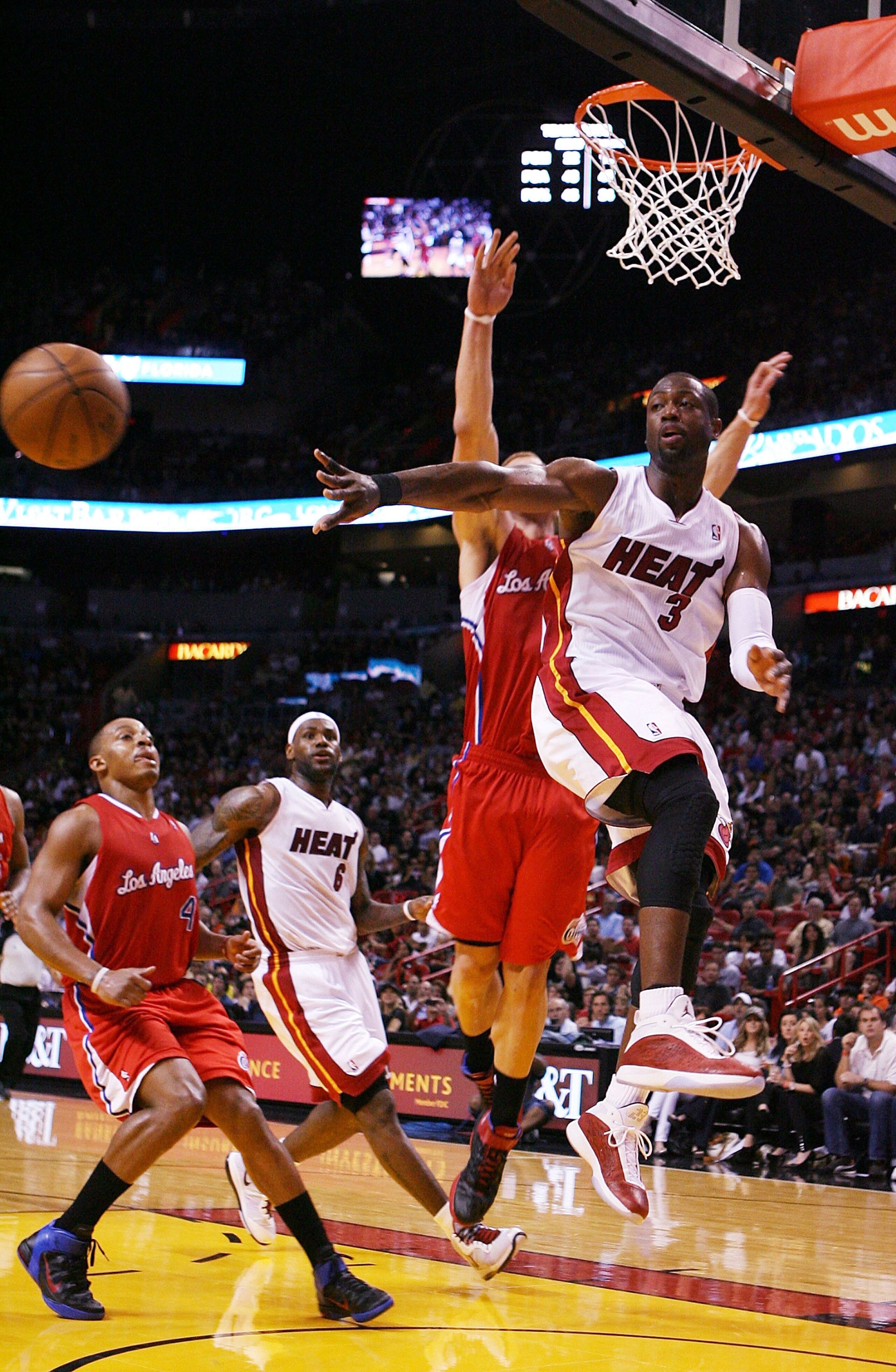 MIAMI - FEBRUARY 06:  Guard Dwyane Wade #3 of the Miami Heat passes against guard Forward Blake Griffin #32 of the L.A. Clippers at American Airlines Arena on February 6, 2011 in Miami, Florida. NOTE TO USER: User expressly acknowledges and agrees that, b