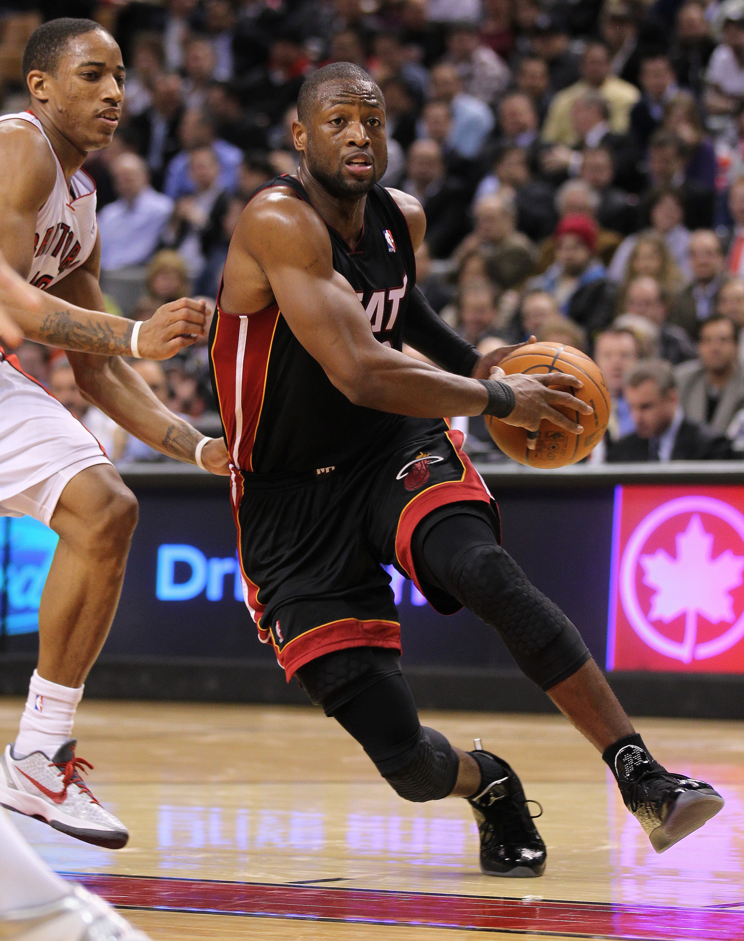 TORONTO, CANADA - FEBRUARY 16:  Dwyane Wade #3 of the Miami Heat drives around DeMar DeRozan #10 of the Toronto Raptors in a game on February 16, 2011 at the Air Canada Centre in Toronto, Canada. The Heat defeated the Raptors 103-95. (Photo by Claus Ander