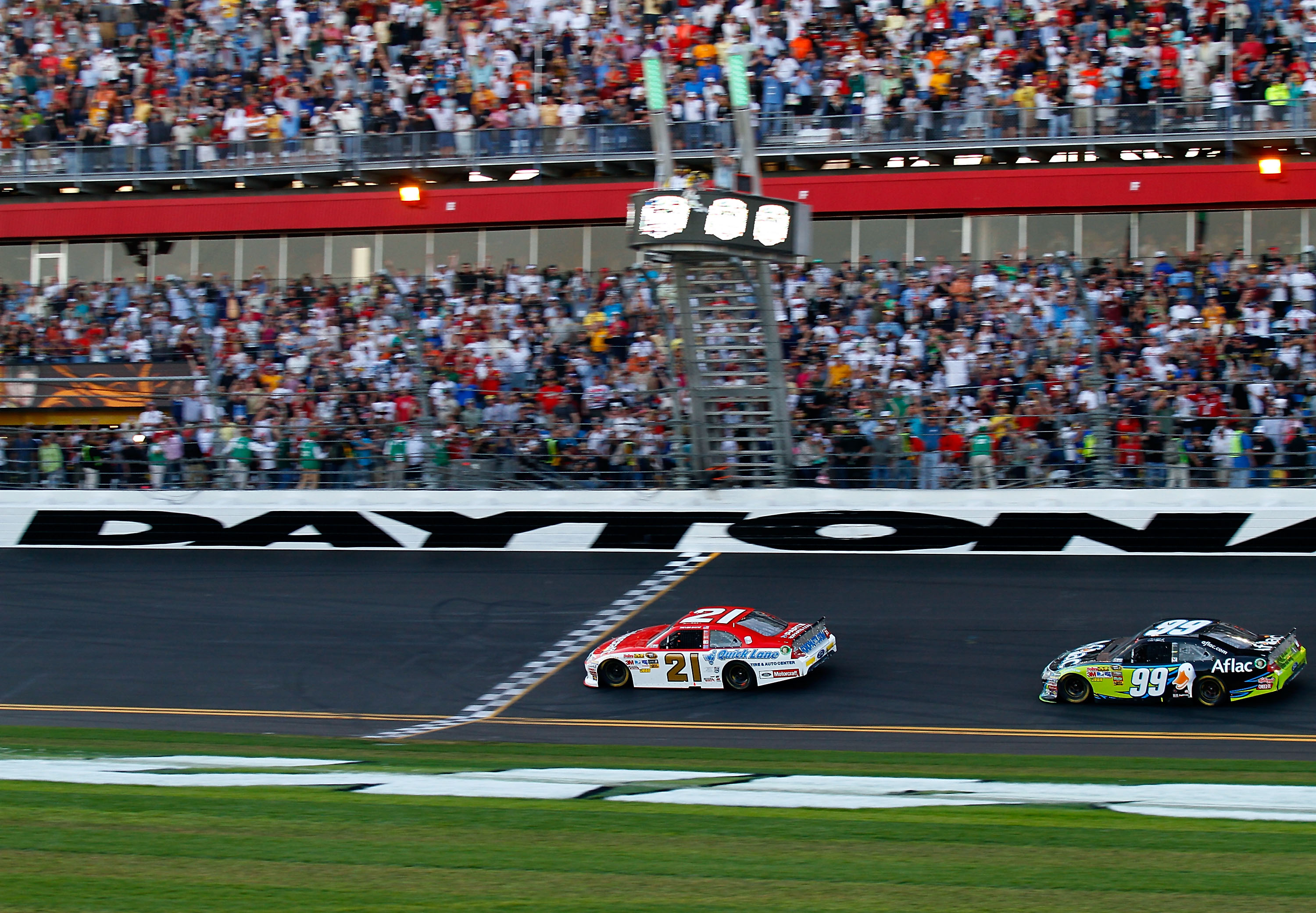 DAYTONA BEACH, FL - FEBRUARY 20:  Trevor Bayne, driver of the #21 Motorcraft/Quick Lane Ford, crosses the finish line to win infront of Carl Edwards, driver of the #99 Aflac Ford during the NASCAR Sprint Cup Series Daytona 500 at Daytona International Spe