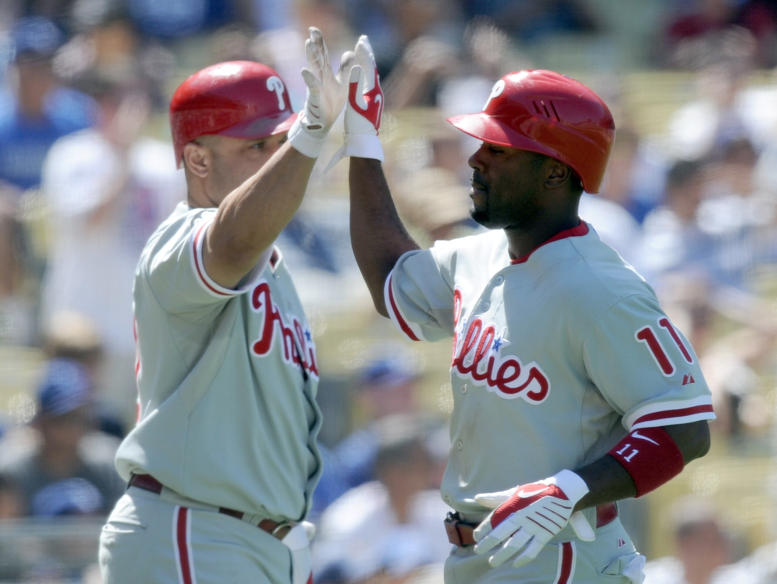 LOS ANGELES, CA - SEPTEMBER 01:  Jimmy Rollins #11 of the Philadelphia Phillies celebrates his run with Placido Polanco #27 off of a Chase Utley #26 double for a 3-0 lead over the Los Angeles Dodgers during the seventh inning at Dodger Stadium on Septembe