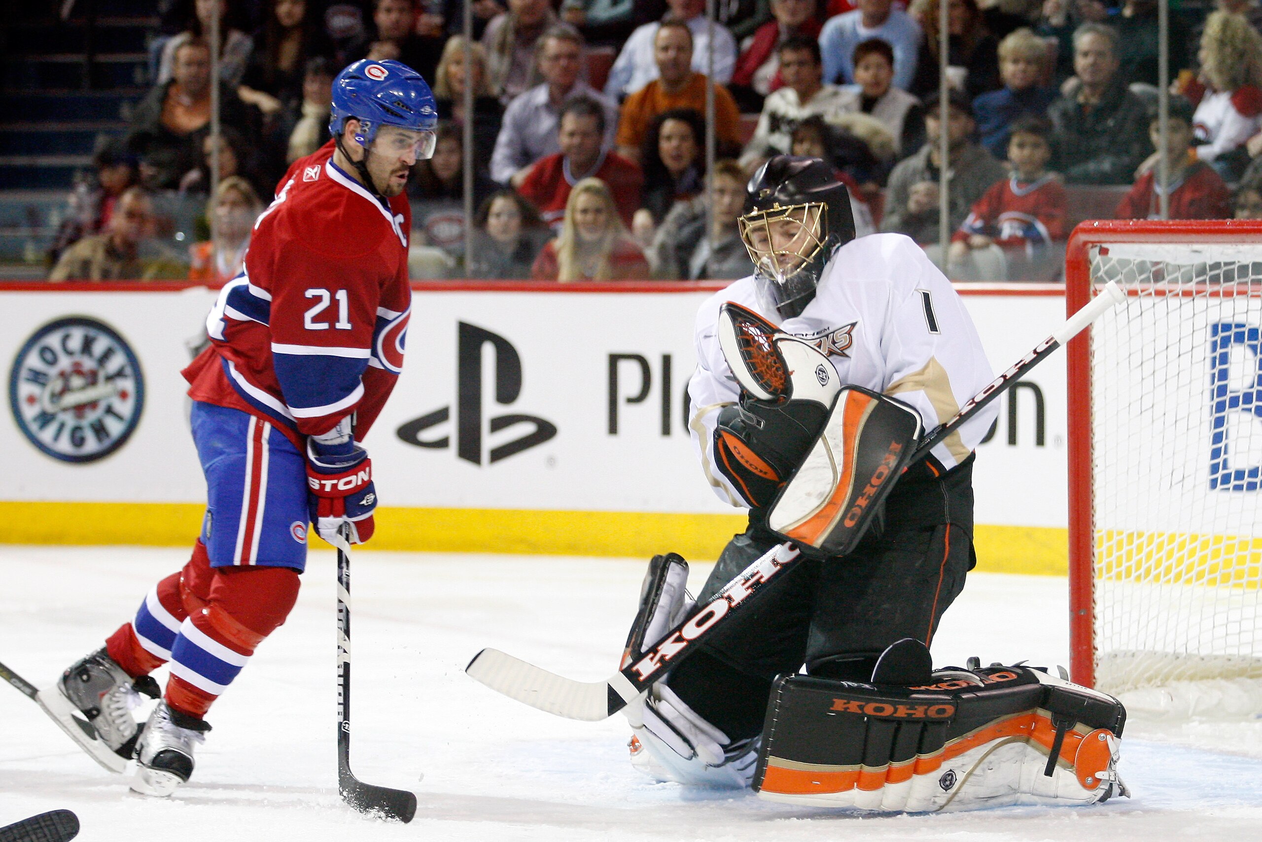 MONTREAL, CANADA - JANUARY 22:  Jonas Hiller #1 of the Anaheim Ducks stops the puck in front of Brian Gionta #21 of the Montreal Canadiens during the NHL game at the Bell Centre on January 22, 2011 in Montreal, Quebec, Canada.  (Photo by Richard Wolowicz/