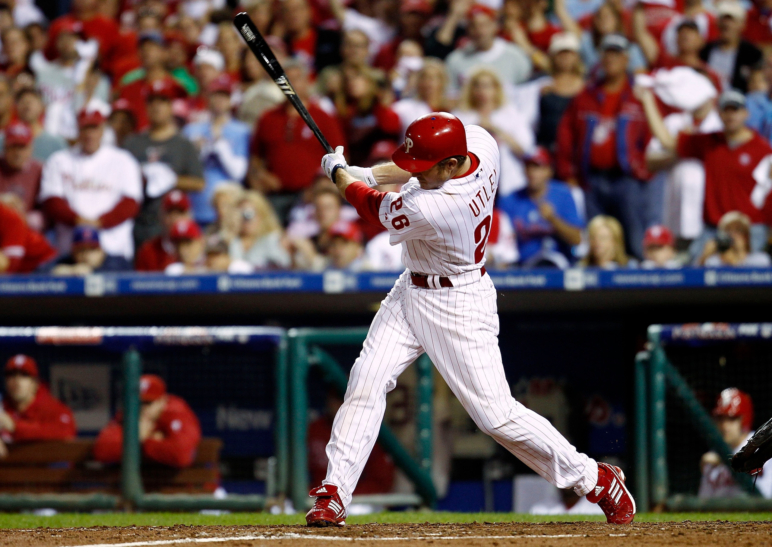 PHILADELPHIA - OCTOBER 08:  Chase Utley #26 of the Philadelphia Phillies hits a 2-RBI single in the fifth inning against the Cincinnati Reds in Game 2 of the NLDS at Citizens Bank Park on October 8, 2010 in Philadelphia, Pennsylvania.  (Photo by Jeff Zele