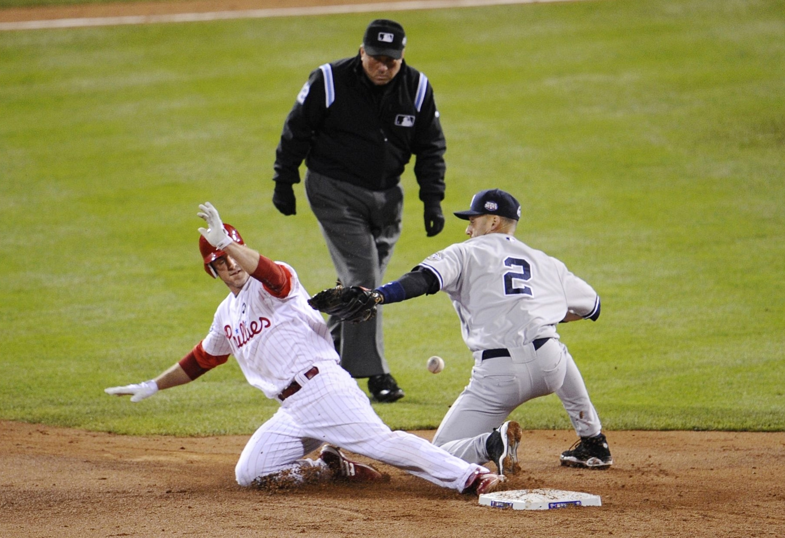PHILADELPHIA - NOVEMBER 02:  Chase Utley #26 of the Philadelphia Phillies steals second base as shortstop Derek Jeter #2 of the New York Yankees drops the ball in the bottom of the third inning of Game Five of the 2009 MLB World Series at Citizens Bank Pa