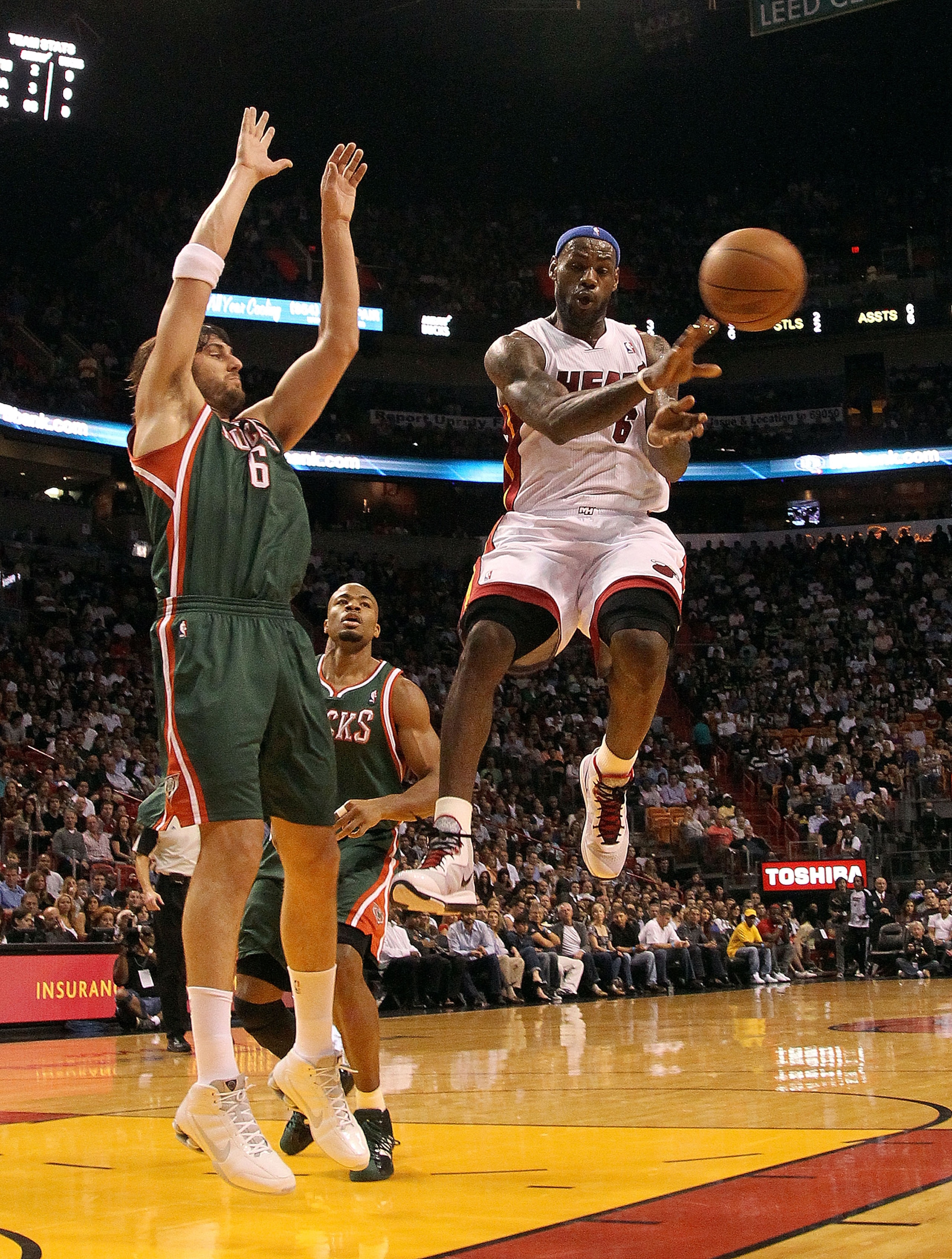MIAMI, FL - JANUARY 04: LeBron James #6 of the Miami Heat passes over Andrew Bogut #6 of the Milwaukee Bucks during a game at American Airlines Arena on January 4, 2011 in Miami, Florida. NOTE TO USER: User expressly acknowledges and agrees that, by down MIAMI, FL - JANUARY 04: LeBron James #6 of the Miami Heat passes over Andrew Bogut #6 of the Milwaukee Bucks during a game at American Airlines Arena on January 4, 2011 in Miami, Florida. NOTE TO USER: User expressly acknowledges and agrees that, by down