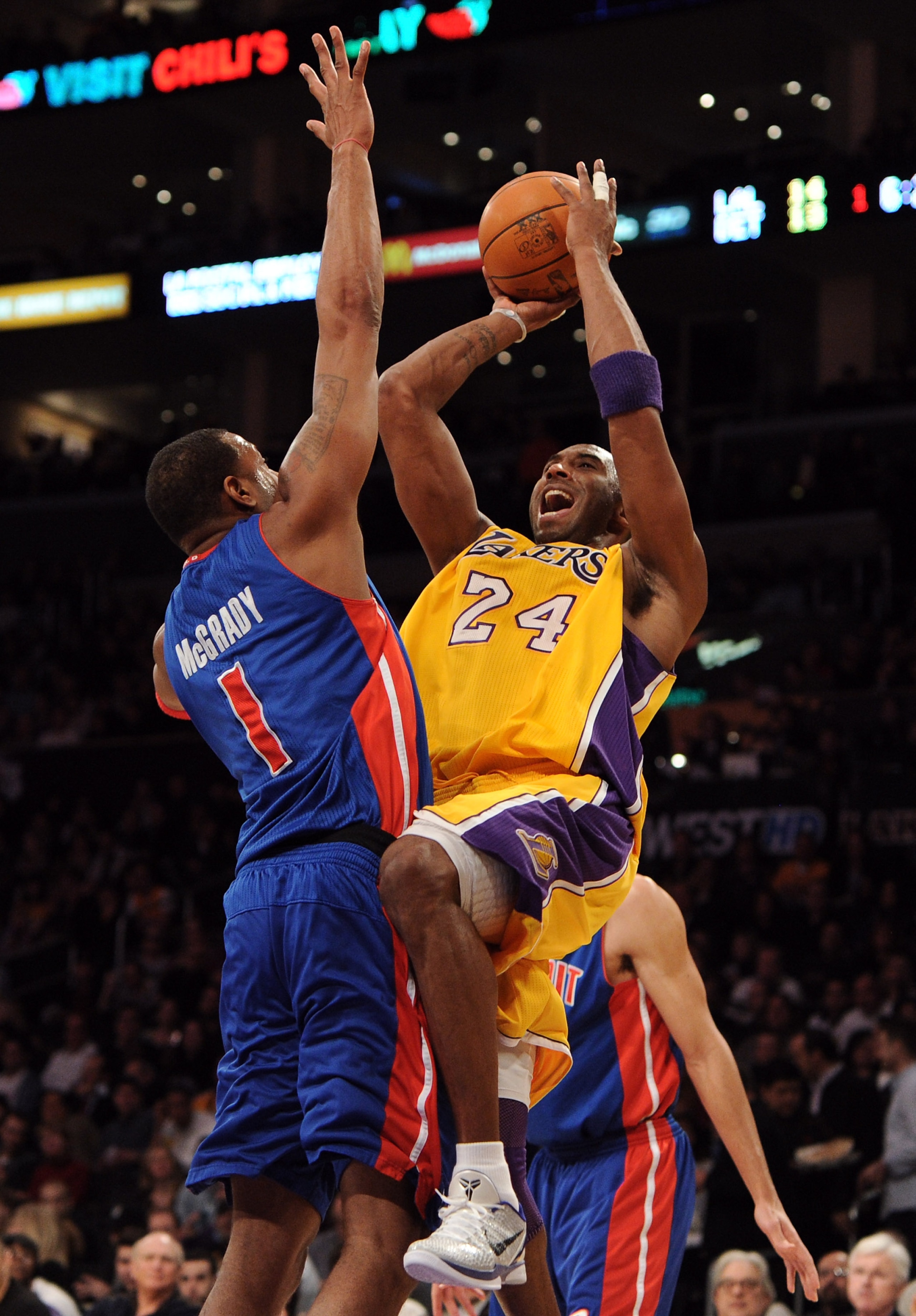 LOS ANGELES, CA - JANUARY 04:  Kobe Bryant #24 of the Los Angeles Lakers shoots a jumper over Tracy McGrady #1 of the Detroit Pistons at the Staples Center on January 4, 2011 in Los Angeles, California. NOTE TO USER: User expressly acknowledges and agrees