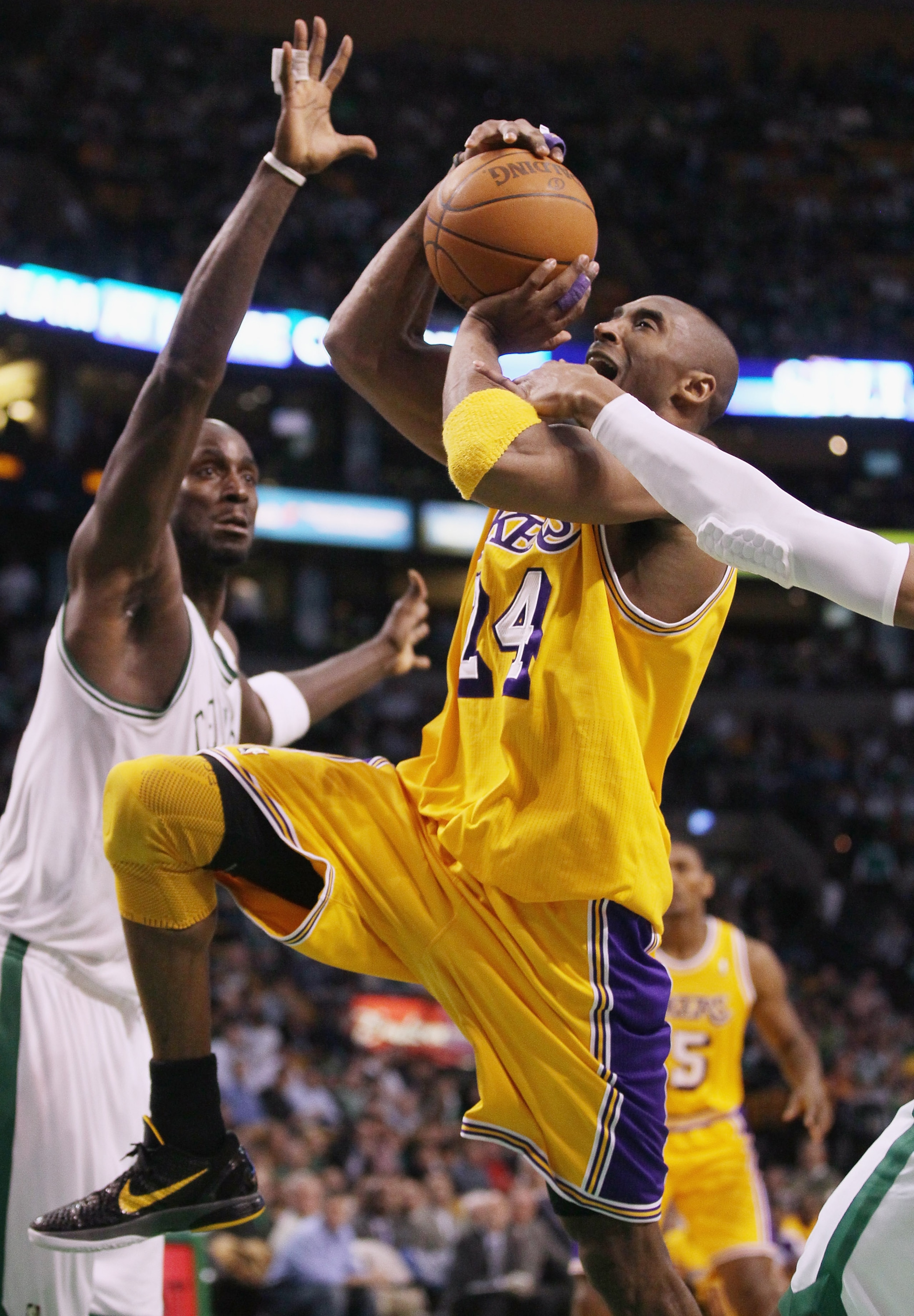 BOSTON, MA - FEBRUARY 10:  Kobe Bryant #24 of the Los Angeles Lakers heads up for the basket as Ray Allen #20 and Kevin Garnett #5 of the Boston Celtics defend on February 10, 2011 at the TD Garden in Boston, Massachusetts.  The Lakers defeated the Celtic