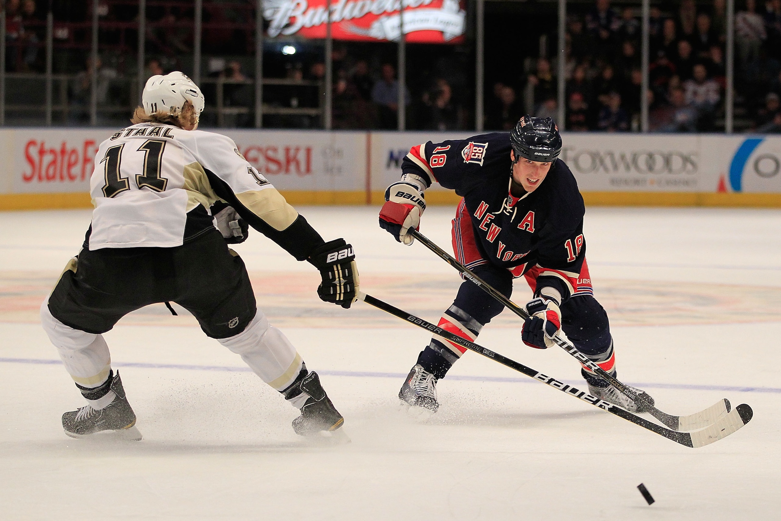 NEW YORK, NY - FEBRUARY 13:  Marc Staal #18 of the New York Rangers shoots past Jordan Staal #11 ofthe Pittsburgh Penguins at Madison Square Garden on February 13, 2011 in New York City. The Rangers defeated the Penguins 5-3.(Photo by Chris Trotman/Getty