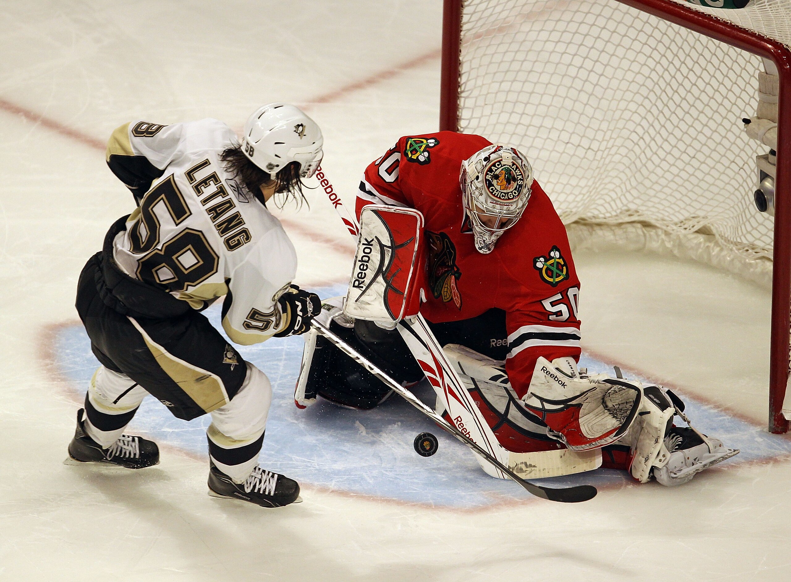 CHICAGO, IL - FEBRUARY 20: Corey Crawford #50 of the Chicago Blackhawks stops a shot in the shootout by Kris Letang #58 of the Pittsburgh Penguins at the United Center on February 20, 2011 in Chicago, Illinois. The Blackhawks defeated the Penguins 3-2 in