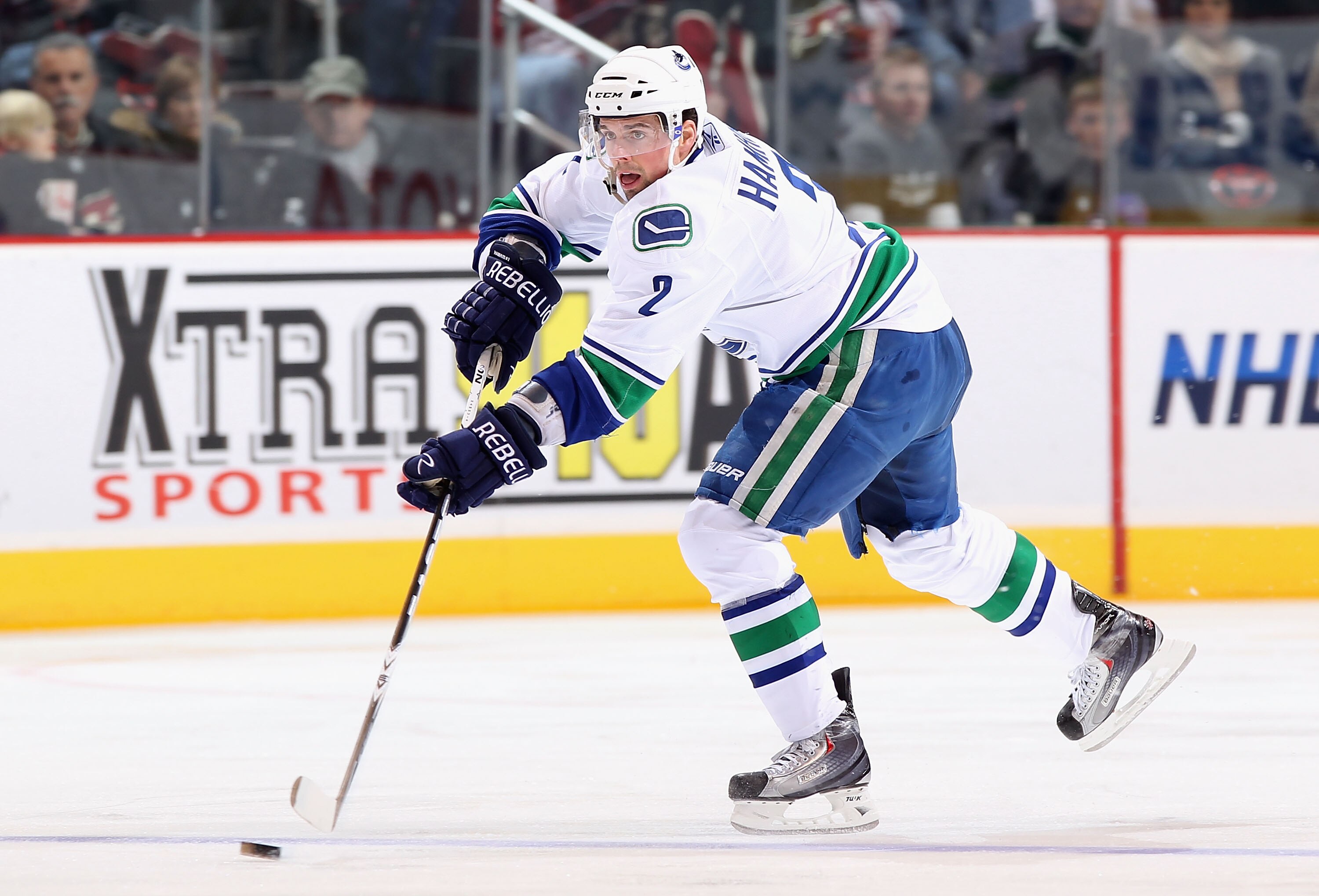 GLENDALE, AZ - FEBRUARY 02:  Dan Hamhuis #2 of the Vancouver Canucks skates with the puck during the NHL game against the Phoenix Coyotes at Jobing.com Arena on February 2, 2011 in Glendale, Arizona.  The Canucks defeated the Coyotes 6-0.  (Photo by Chris