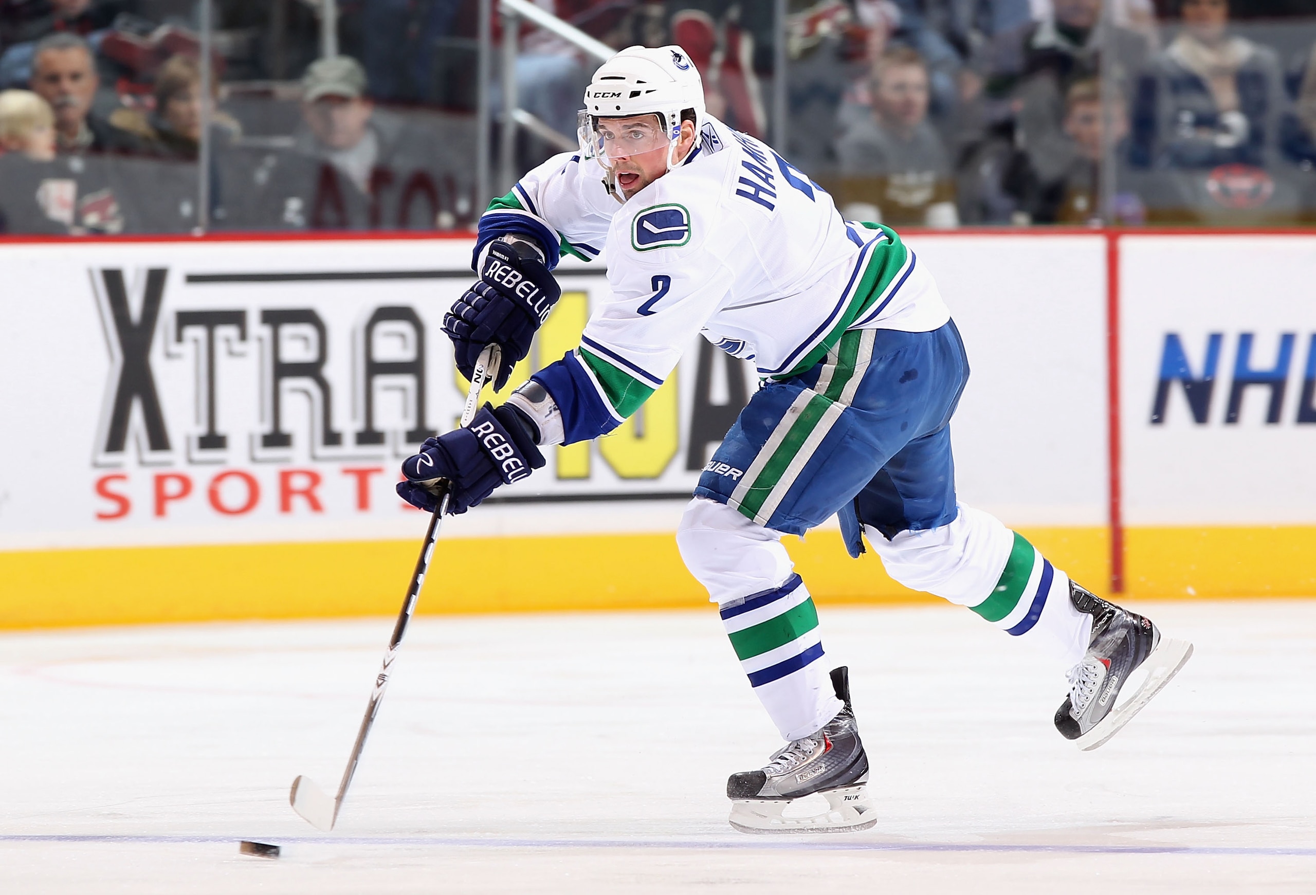 GLENDALE, AZ - FEBRUARY 02:  Dan Hamhuis #2 of the Vancouver Canucks skates with the puck during the NHL game against the Phoenix Coyotes at Jobing.com Arena on February 2, 2011 in Glendale, Arizona.  The Canucks defeated the Coyotes 6-0.  (Photo by Chris
