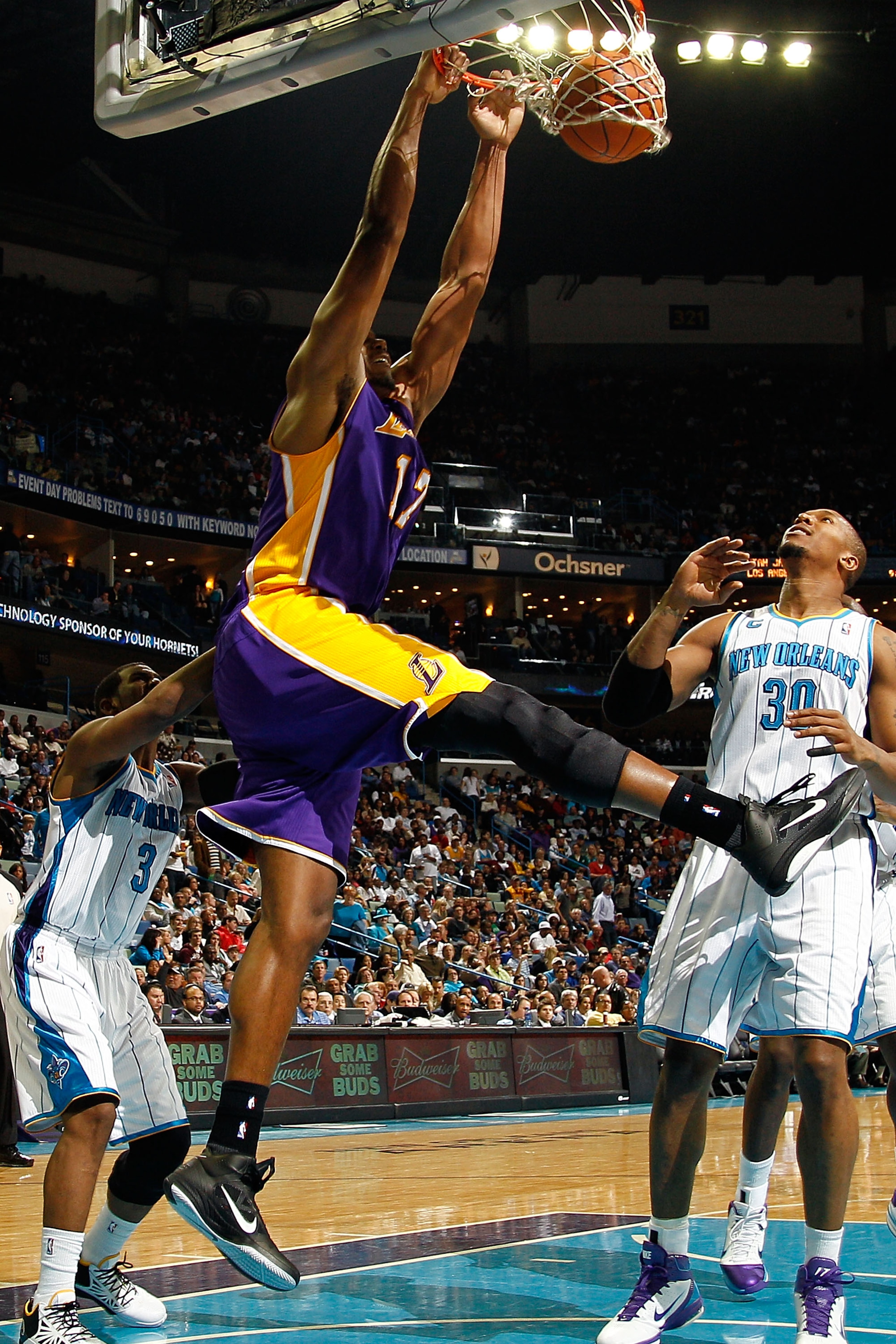 NEW ORLEANS, LA - DECEMBER 29:  Andrew Bynum #17 of the Los Angeles Lakers dunks the ball over Daivd West #30 of the New Orleans Hornets at the New Orleans Arena on December 29, 2010 in New Orleans, Louisiana.   The Lakers defeated the Hornets 103-88.  NO