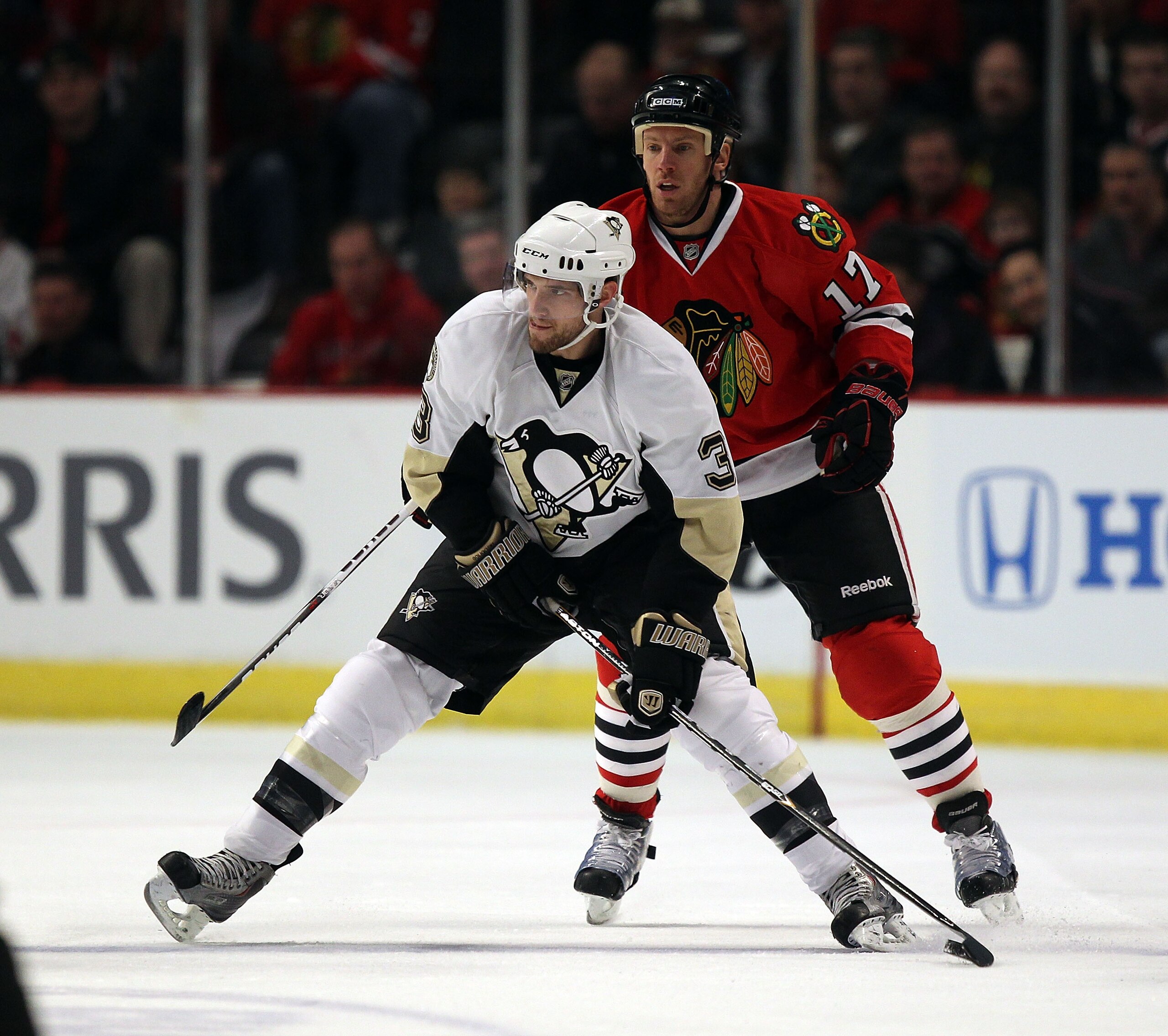 CHICAGO, IL - FEBRUARY 20: Alex Goligoski #3 of the Pittsburgh Penguins looks to pass in front of Ryan Johnson #17 of the Chicago Blackhawks at the United Center on February 20, 2011 in Chicago, Illinois. (Photo by Jonathan Daniel/Getty Images)