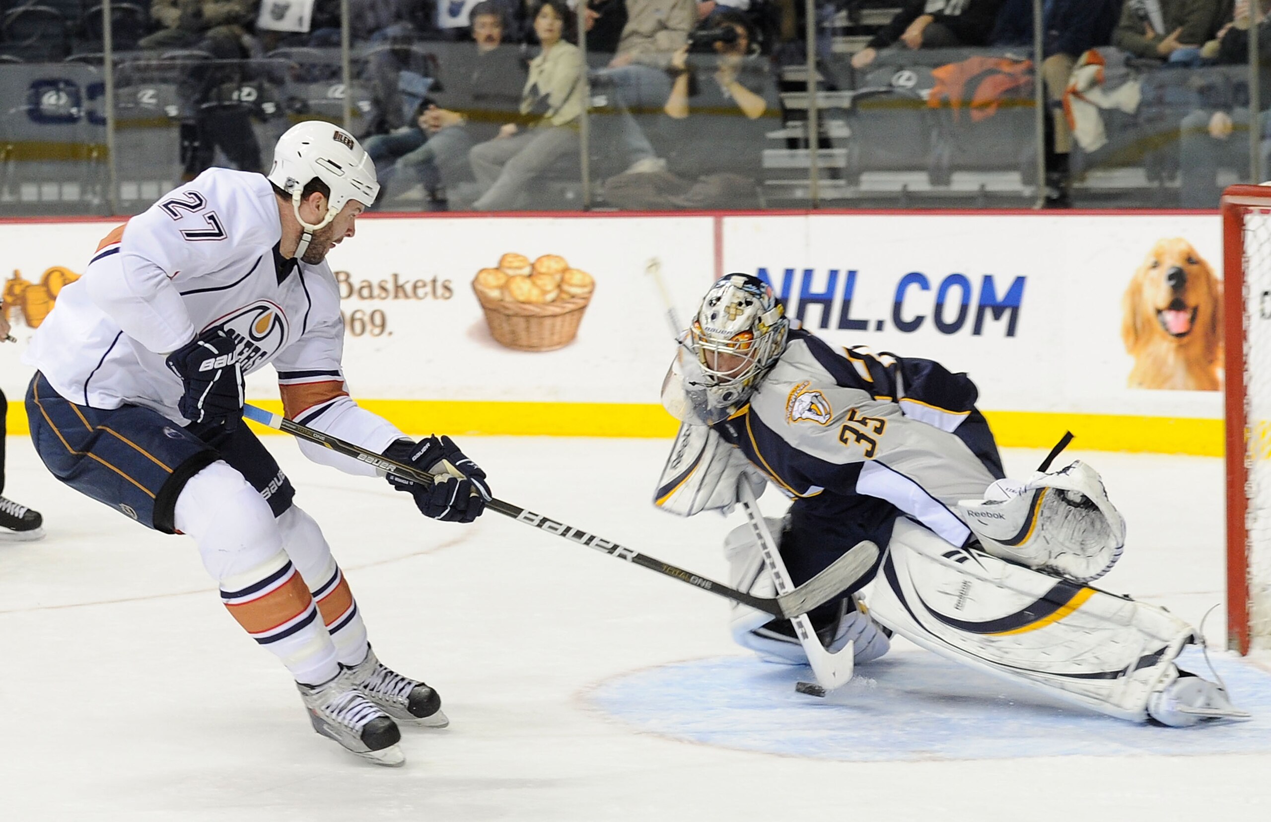 NASHVILLE, TN - FEBRUARY 07:  Pekka Rinne #35 of the Nashville Predators makes a save on Dustin Penner #27 of the Edmonton Oilers on February 7, 2011 at the Bridgestone Arena in Nashville, Tennessee.  (Photo by Frederick Breedon/Getty Images)