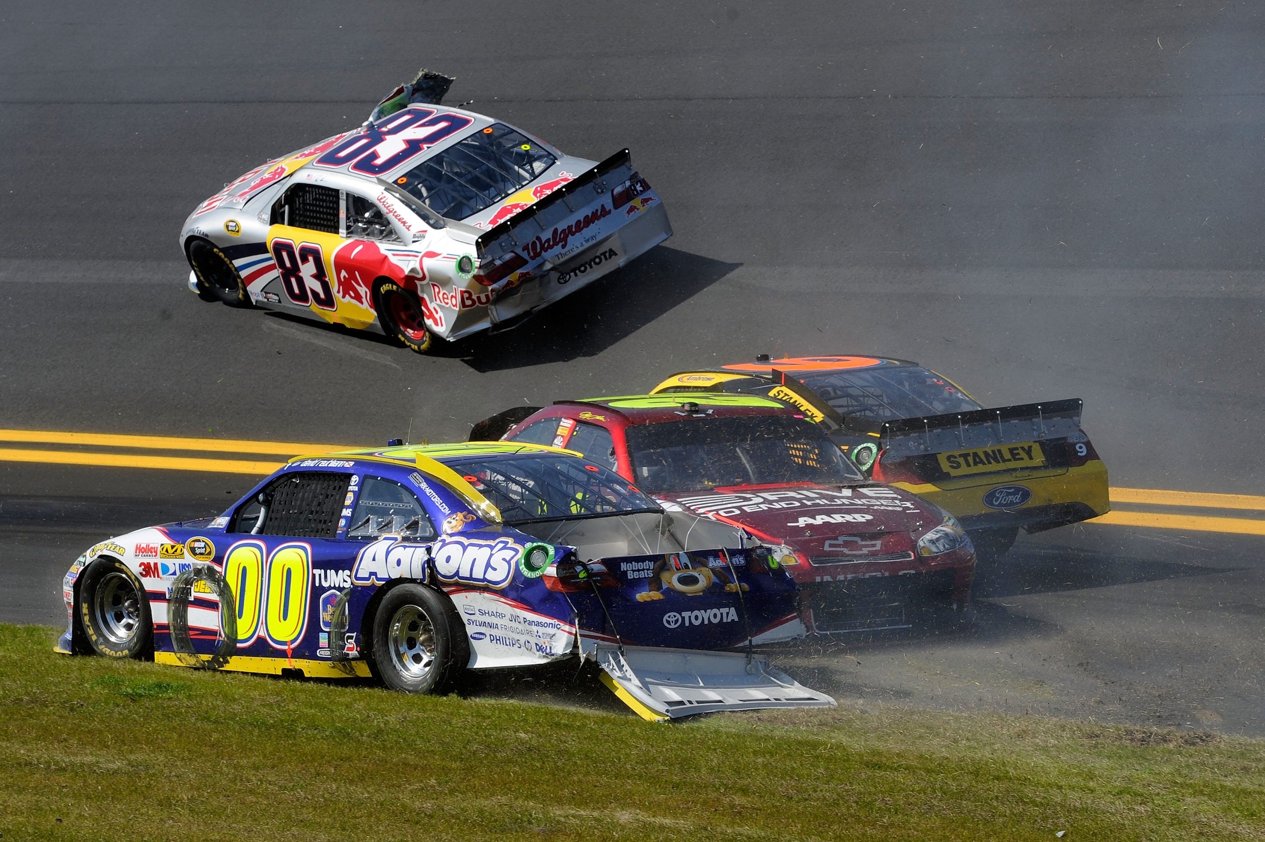 DAYTONA BEACH, FL - FEBRUARY 20:  Brian Vickers, driver of the #83 Red Bull Toyota, Marcos Ambrose, driver of the #9 Stanley Ford, Jeff Gordon, driver of the #24 Drive to End Hunger Chevrolet, and David Reutimann, driver of the #00 Aaron's Dream Machine T