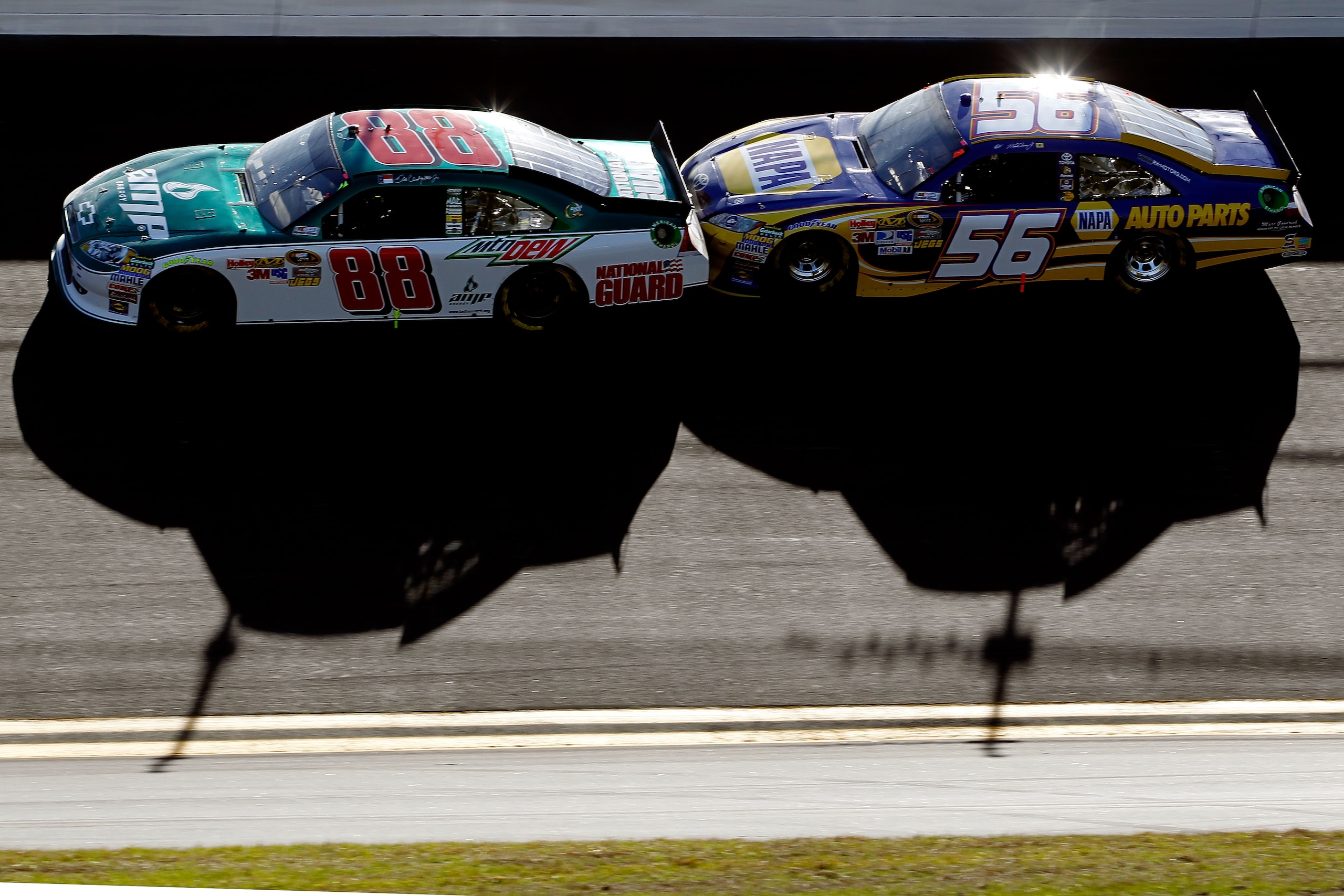 DAYTONA BEACH, FL - FEBRUARY 20:  Dale Earnhardt Jr., driver of the #88 National Guard/AMP Energy Chevrolet, and Martin Truex Jr., driver of the #56 NAPA Toyota, race during the NASCAR Sprint Cup Series Daytona 500 at Daytona International Speedway on Feb