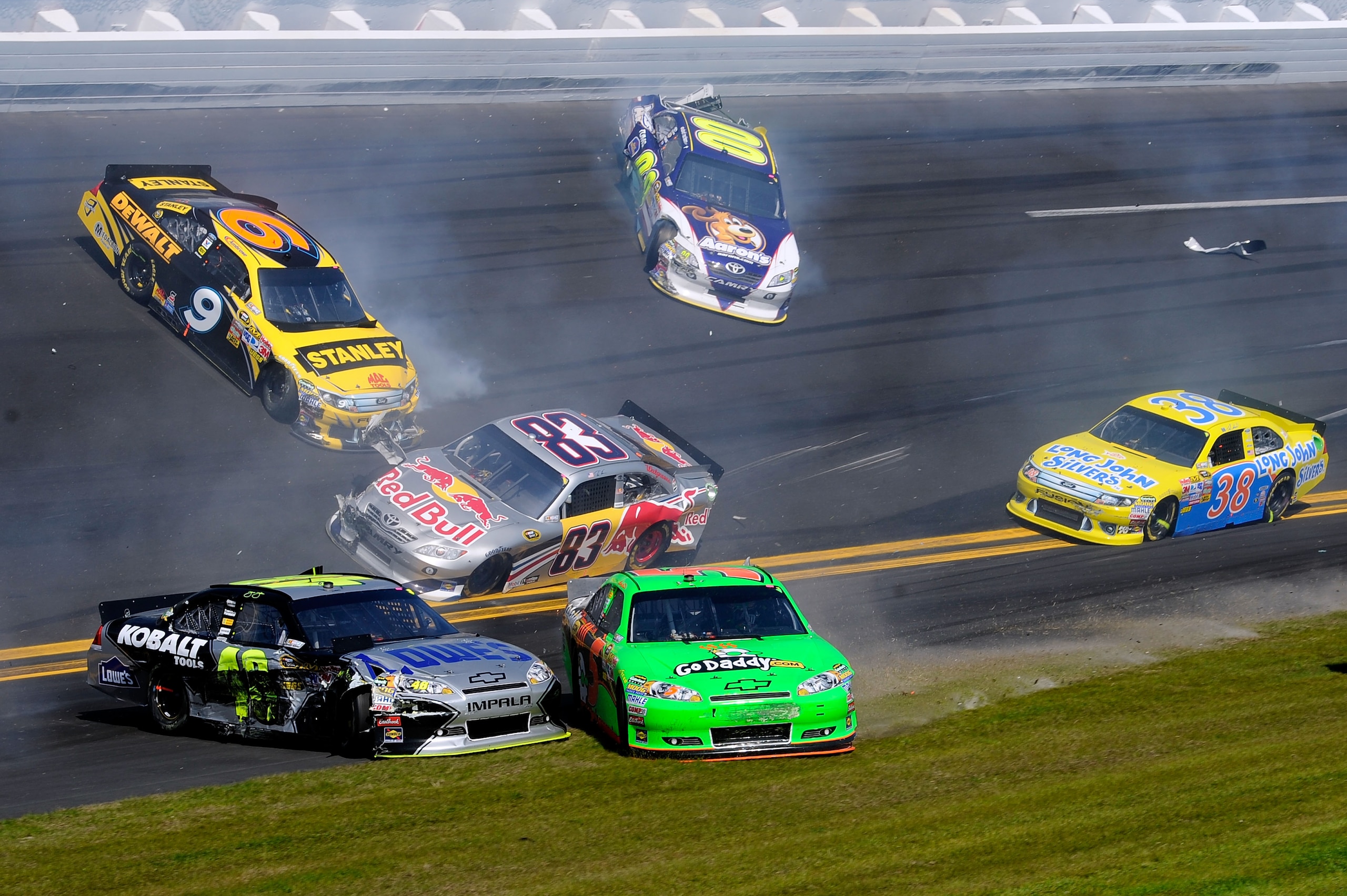 DAYTONA BEACH, FL - FEBRUARY 20:  Marcos Ambrose, driver of the #9 Stanley Ford, David Reutimann, driver of the #00 Aaron's Dream Machine Toyota, Brian Vickers, driver of the #83 Red Bull Toyota, Jimmie Johnson, driver of the #48 Lowe's Chevrolet, and Mar