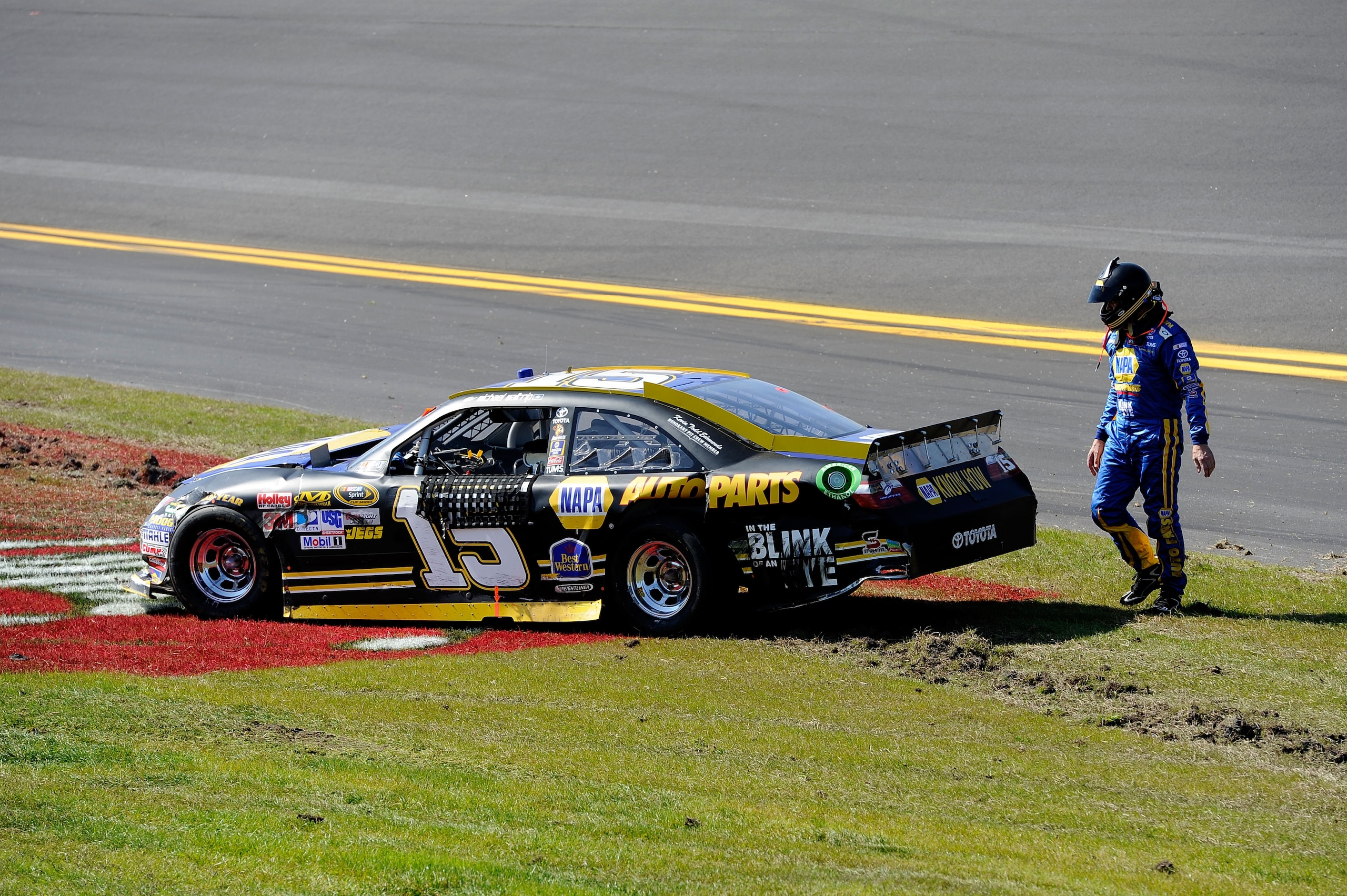 DAYTONA BEACH, FL - FEBRUARY 20:  Michael Waltrip, driver of the #15 NAPA Auto Parts Toyota, looks at his car after an incident during the NASCAR Sprint Cup Series Daytona 500 at Daytona International Speedway on February 20, 2011 in Daytona Beach, Florid