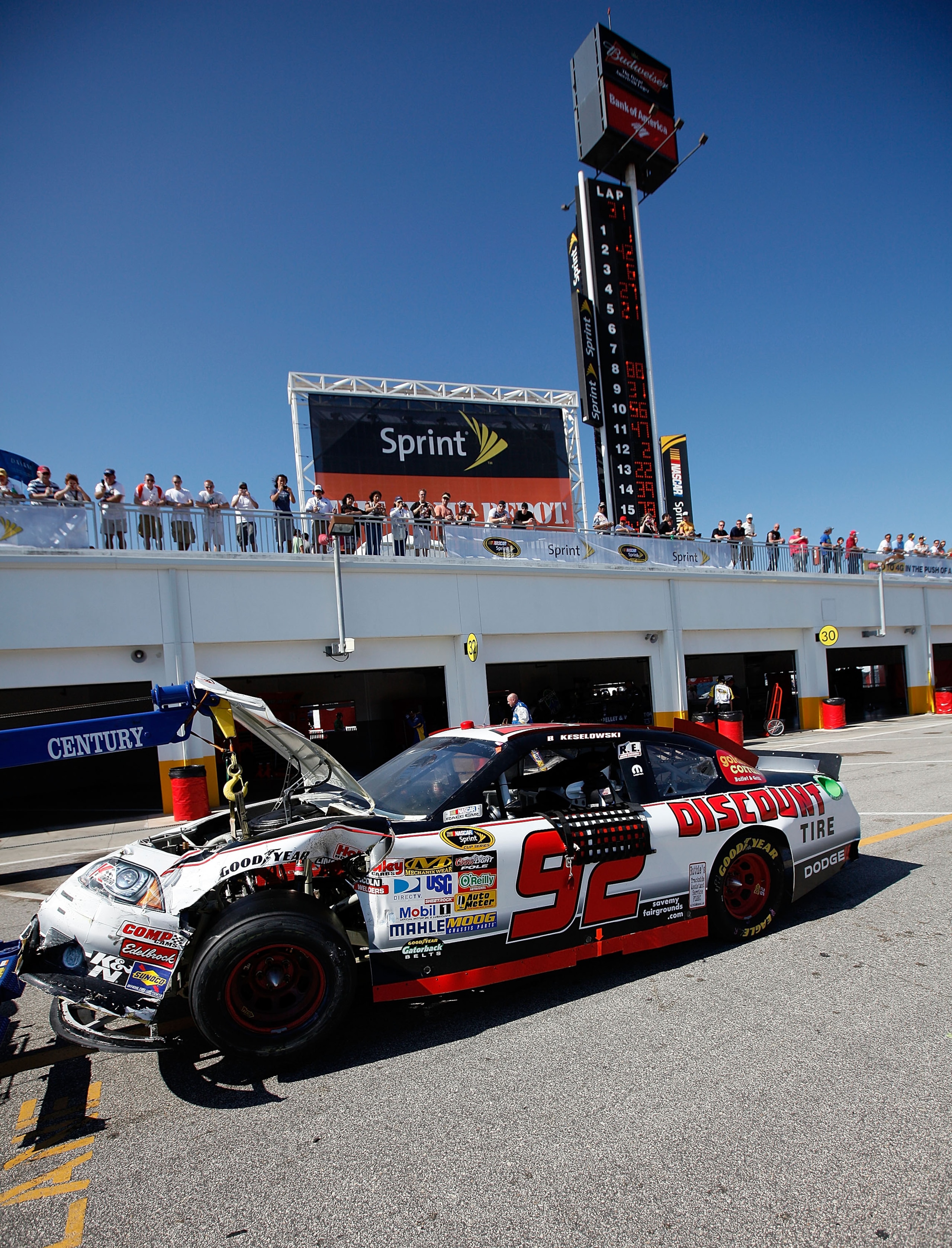 DAYTONA BEACH, FL - FEBRUARY 20:  The #92 Discount Tire Dodge of Brian Keselowski is towed through the garage area after an incident during the NASCAR Sprint Cup Series Daytona 500 at Daytona International Speedway on February 20, 2011 in Daytona Beach, F
