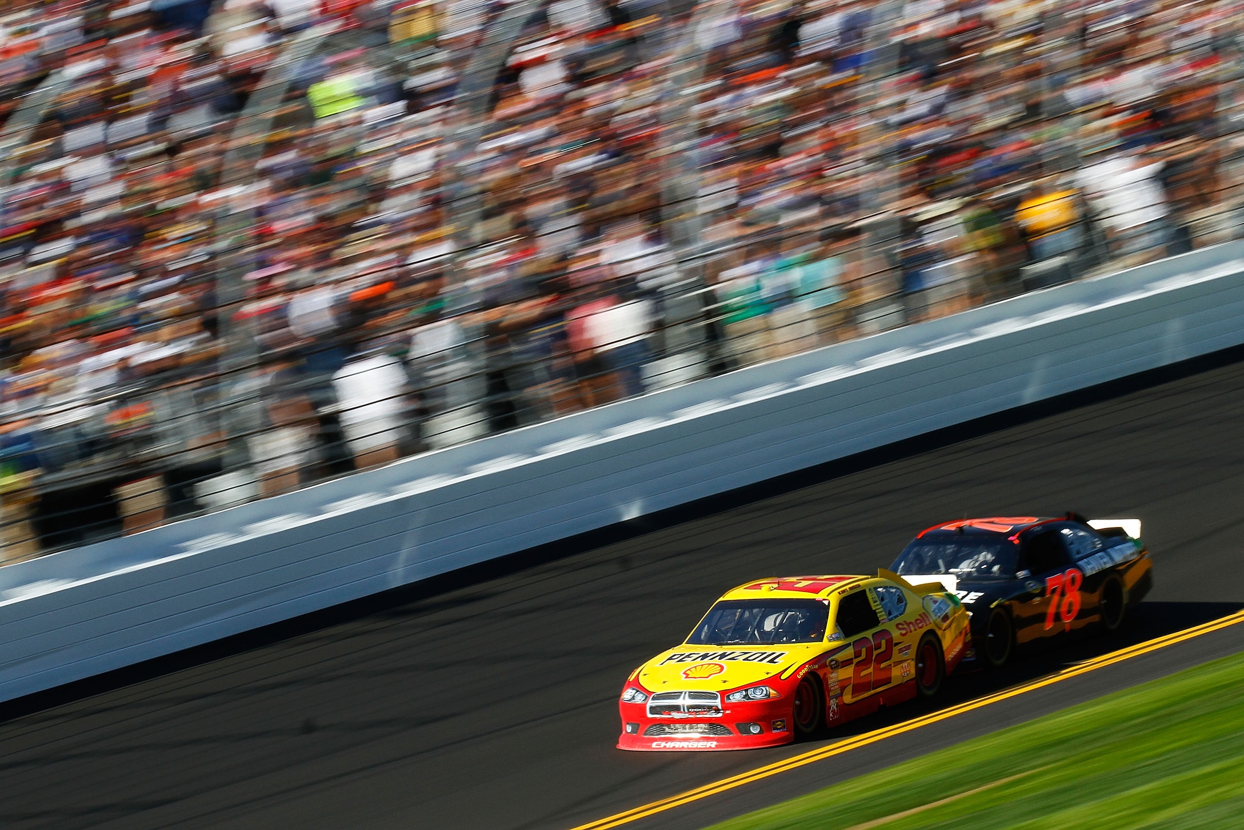 DAYTONA BEACH, FL - FEBRUARY 20:  Kurt Busch, driver of the #22 Shell Pennzoil Dodge, and Regan Smith, driver of the #78 Furniture Row Racing Chevrolet, race during the NASCAR Sprint Cup Series Daytona 500 at Daytona International Speedway on February 20,