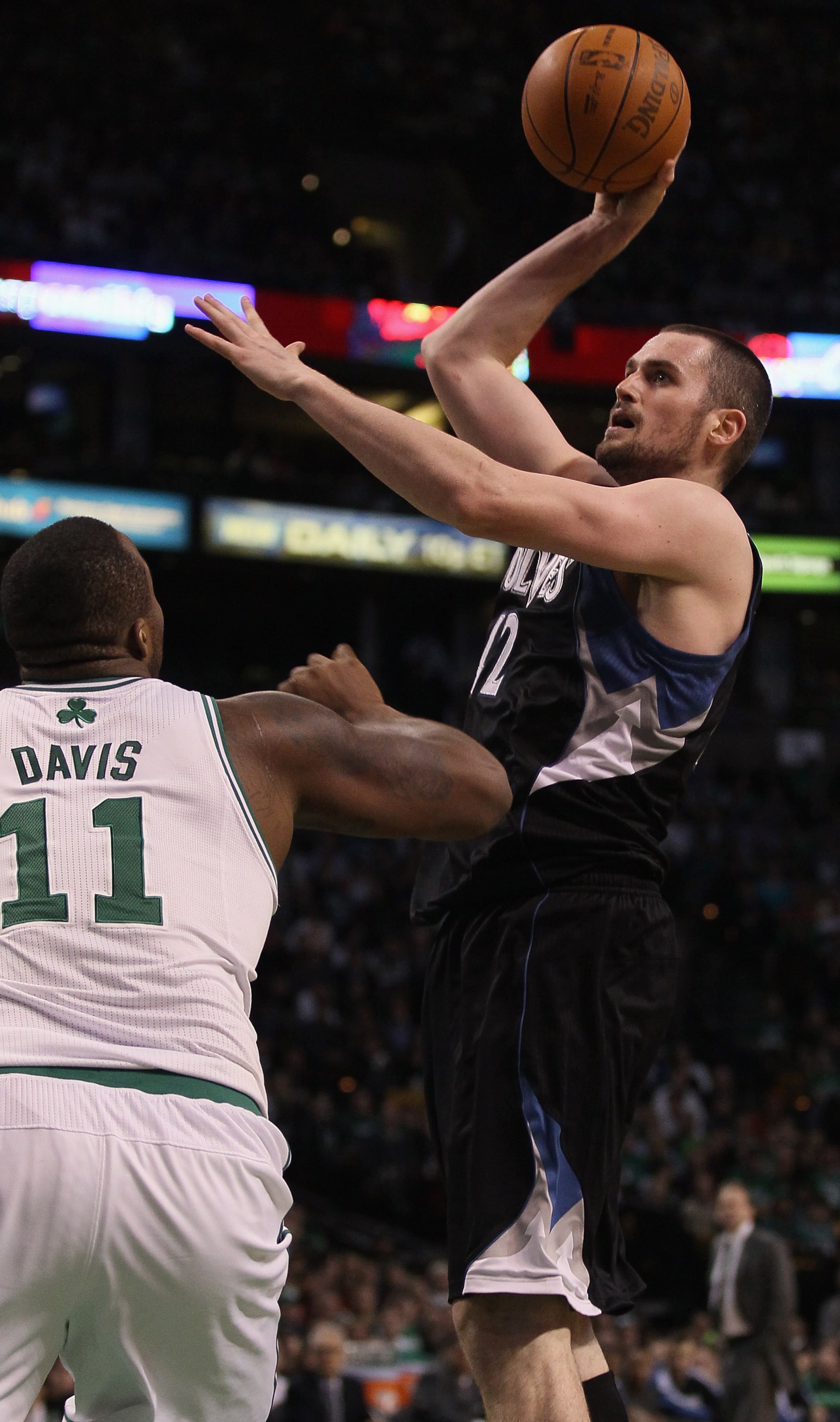 BOSTON, MA - JANUARY 03: Kevin Love #42 of the Minnesota Timberwolves takes a shot as Glen Davis #11 of the Boston Celtics defends on January 3, 2011 at the TD Garden in Boston, Massachusetts. The Celtics defeated the Timberwolves 96-93. NOTE TO USER: Us BOSTON, MA - JANUARY 03: Kevin Love #42 of the Minnesota Timberwolves takes a shot as Glen Davis #11 of the Boston Celtics defends on January 3, 2011 at the TD Garden in Boston, Massachusetts. The Celtics defeated the Timberwolves 96-93. NOTE TO USER: Us