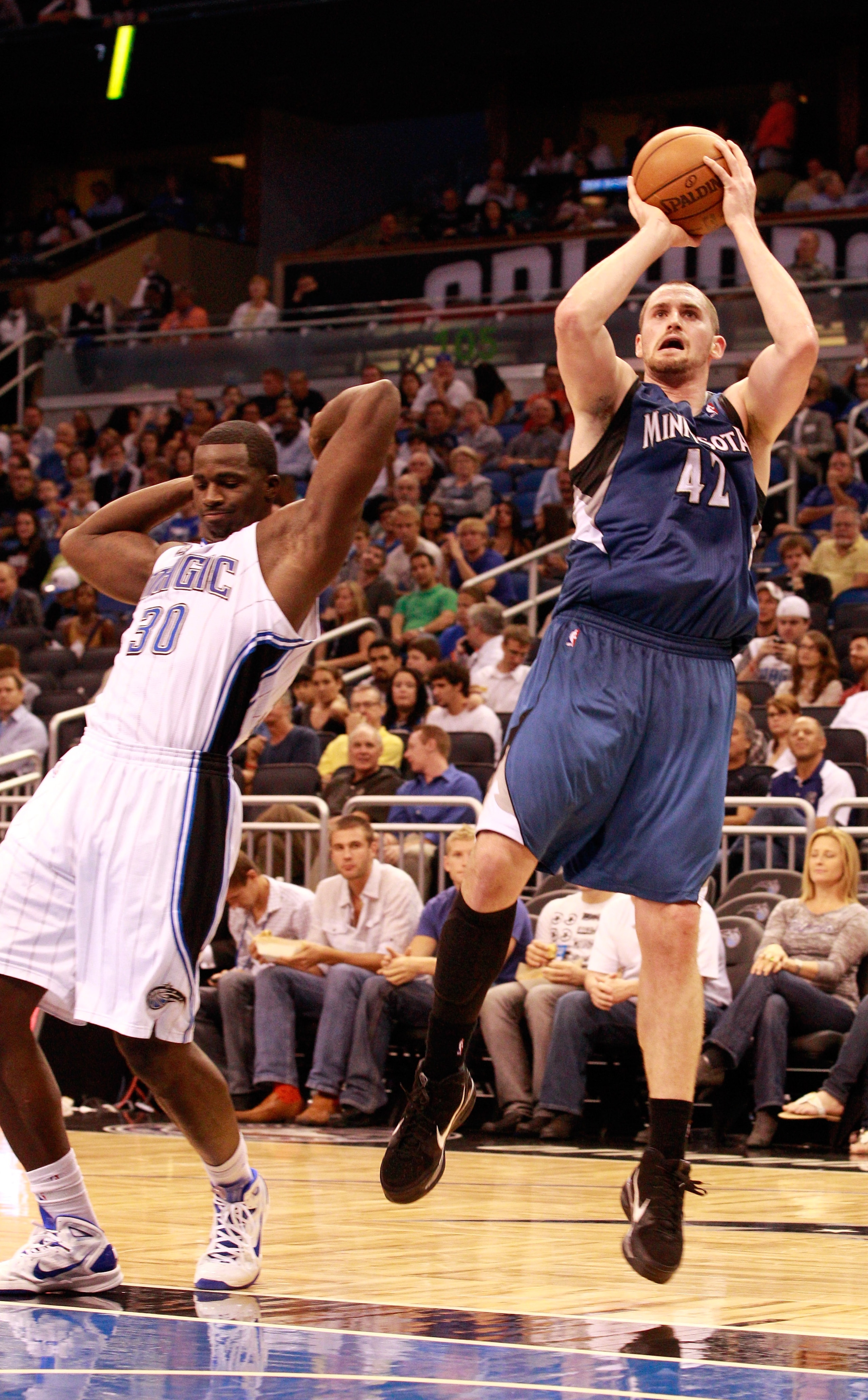 ORLANDO, FL - NOVEMBER 03: Kevin Love #42 of the Minnesota Timberwolves attempts a shot over Brandon Bass #30 of the Orlando Magic during the game at Amway Arena on November 3, 2010 in Orlando, Florida. NOTE TO USER: User expressly acknowledges and agre ORLANDO, FL - NOVEMBER 03: Kevin Love #42 of the Minnesota Timberwolves attempts a shot over Brandon Bass #30 of the Orlando Magic during the game at Amway Arena on November 3, 2010 in Orlando, Florida. NOTE TO USER: User expressly acknowledges and agre