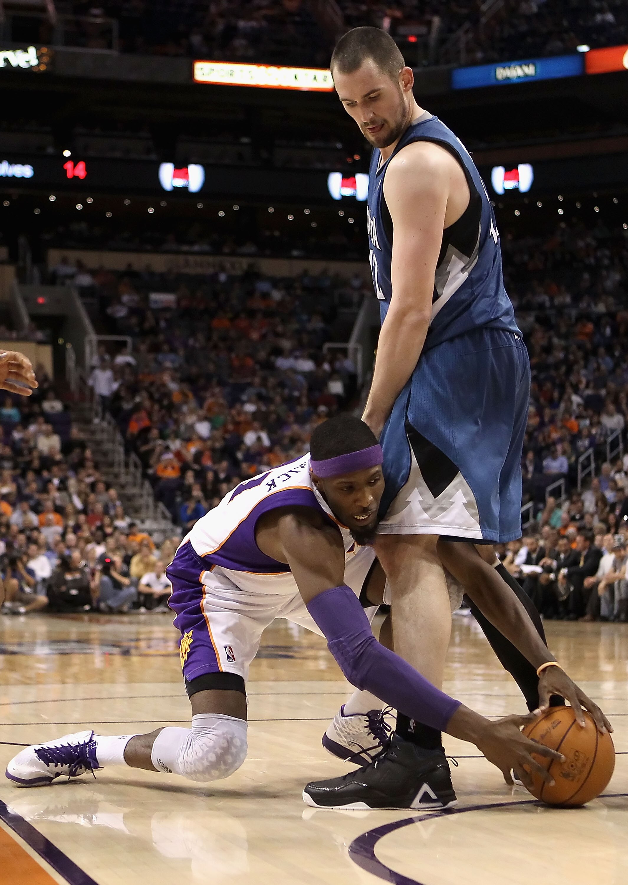 PHOENIX - DECEMBER 15:   Hakim Warrick #21 of the Phoenix Suns attempts to control the ball through the legs of Kevin Love #42 of the Minnesota Timberwolves during the NBA game at US Airways Center on December 15, 2010 in Phoenix, Arizona. The Suns defeat