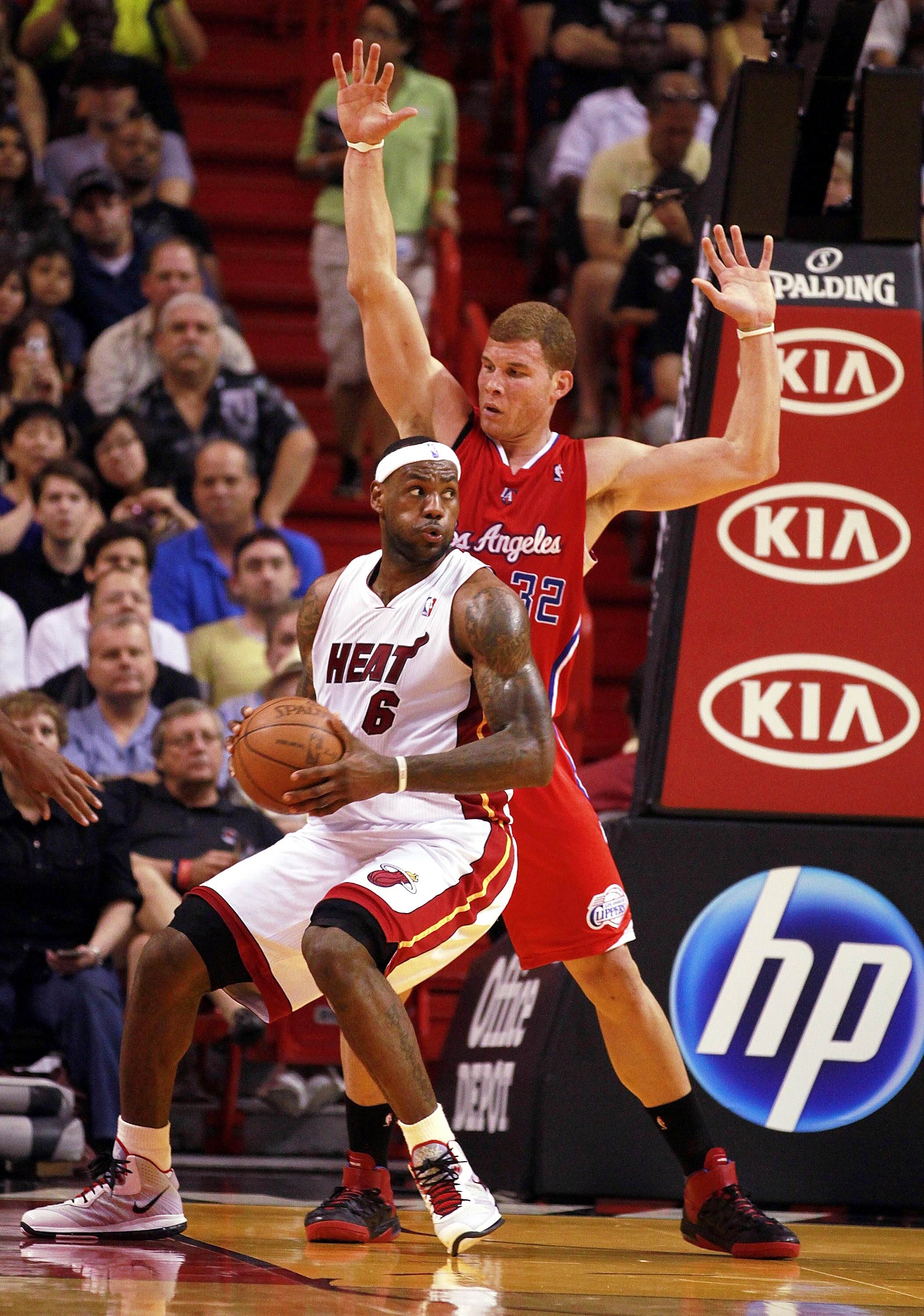 MIAMI - FEBRUARY 06:  Forward LeBron James #6 of the Miami Heat passes against guard Forward Blake Griffin #32 of the L.A. Clippers at American Airlines Arena on February 6, 2011 in Miami, Florida. NOTE TO USER: User expressly acknowledges and agrees that
